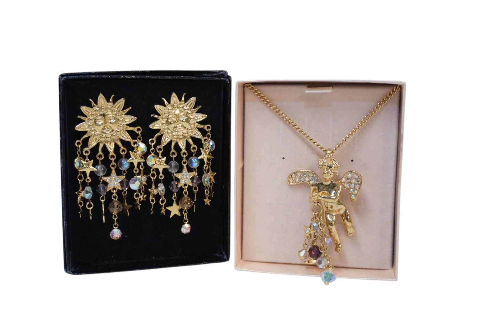 KIRKS FOLLY CHERUB NECKLACE AND SUN EARRINGS: Kirks Folly Cherub Necklace with Dangling Charms and Dangling Sun Face Earrings. Both are still in original boxes which measure about 3.25" x 4" and total lot weight is 4.3 oz.