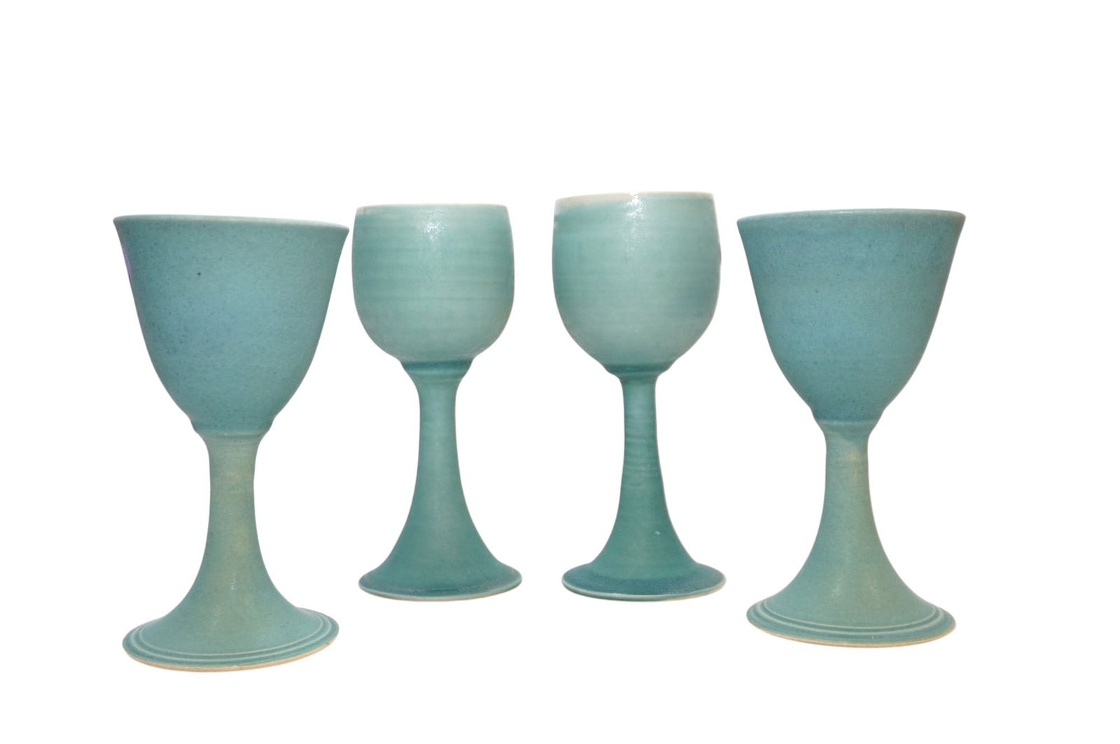 4 STUDIO ART POTTERY TEAL GOBLETS: 4 Studio Art Pottery Vintage Goblets. 2 are 7 1/2" and 2 are 6.75". Weight on all 2 pds 10 oz: Provenance: A Rainbow Row, Charleston Private Estate