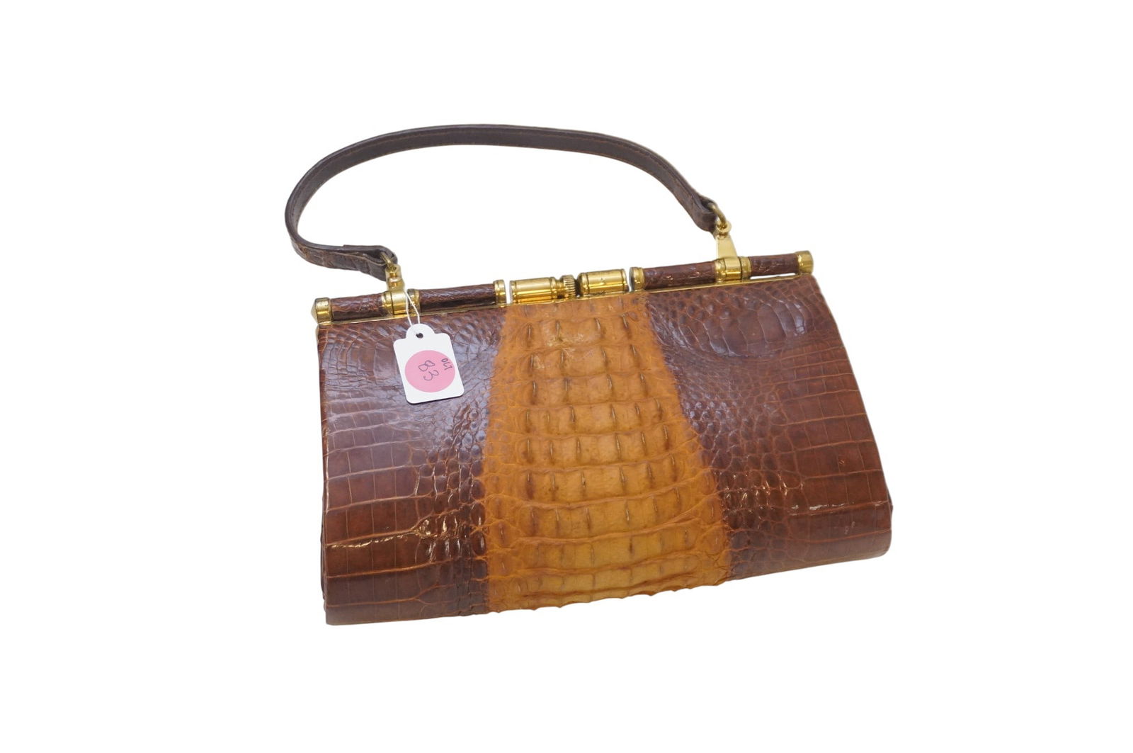 1950-60s RIDGED ALLIGATOR HANDBAG: 1950-60s Ridged Alligator Handbag. Features brass hardware and brown leather interior. Measures 8.5" x 2.25" x 10" and weighs 13.7 oz.