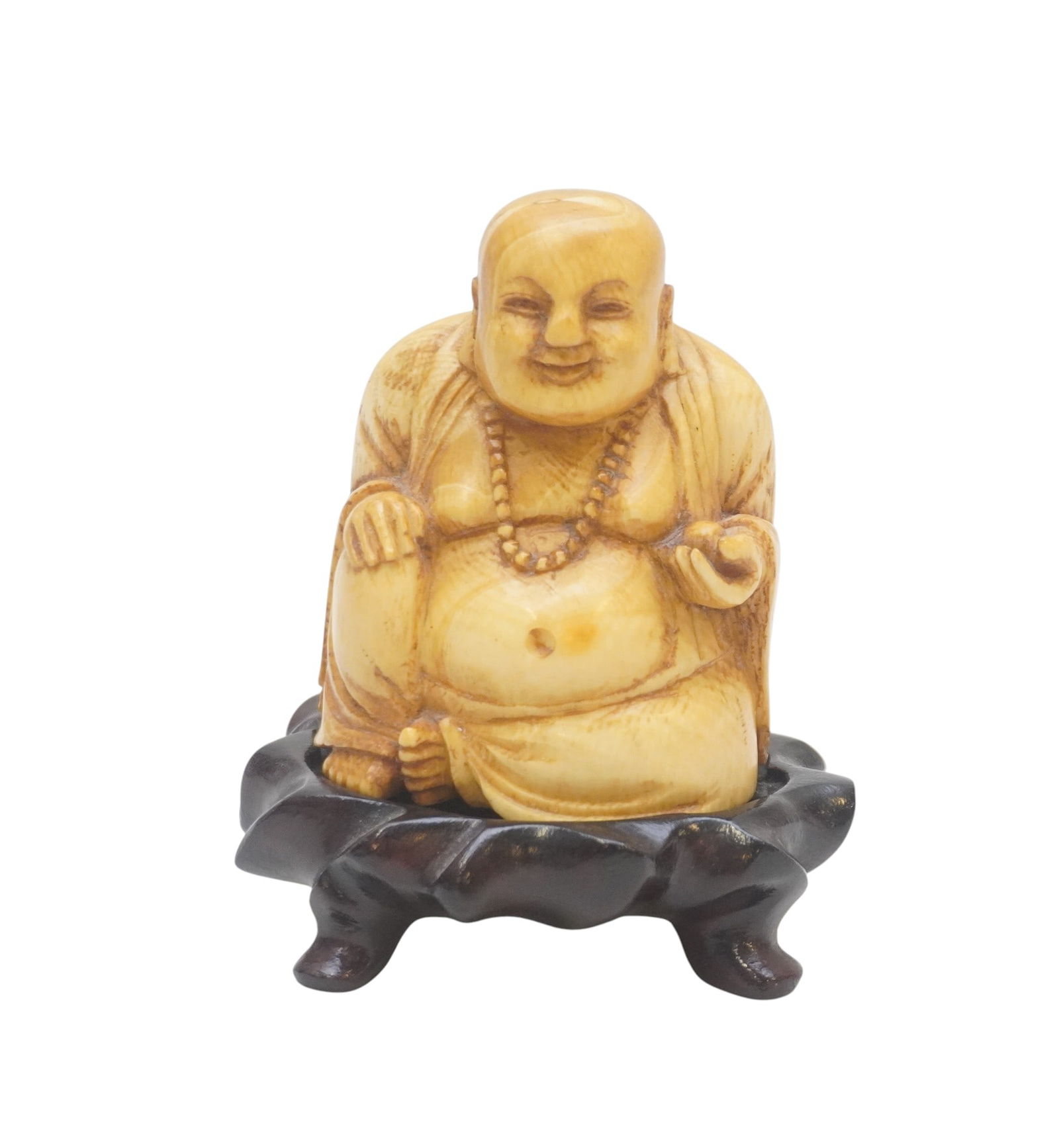 VINTAGE CARVED BONE JAPANESE HOTEI OKIMONO: A Japanese finely carved bone okimono of Hotei holding a peach, sitting in textured robes, on carved wood stand. Measures 3'x2 1/2"x4 1/4" on stand. Weight 9 oz