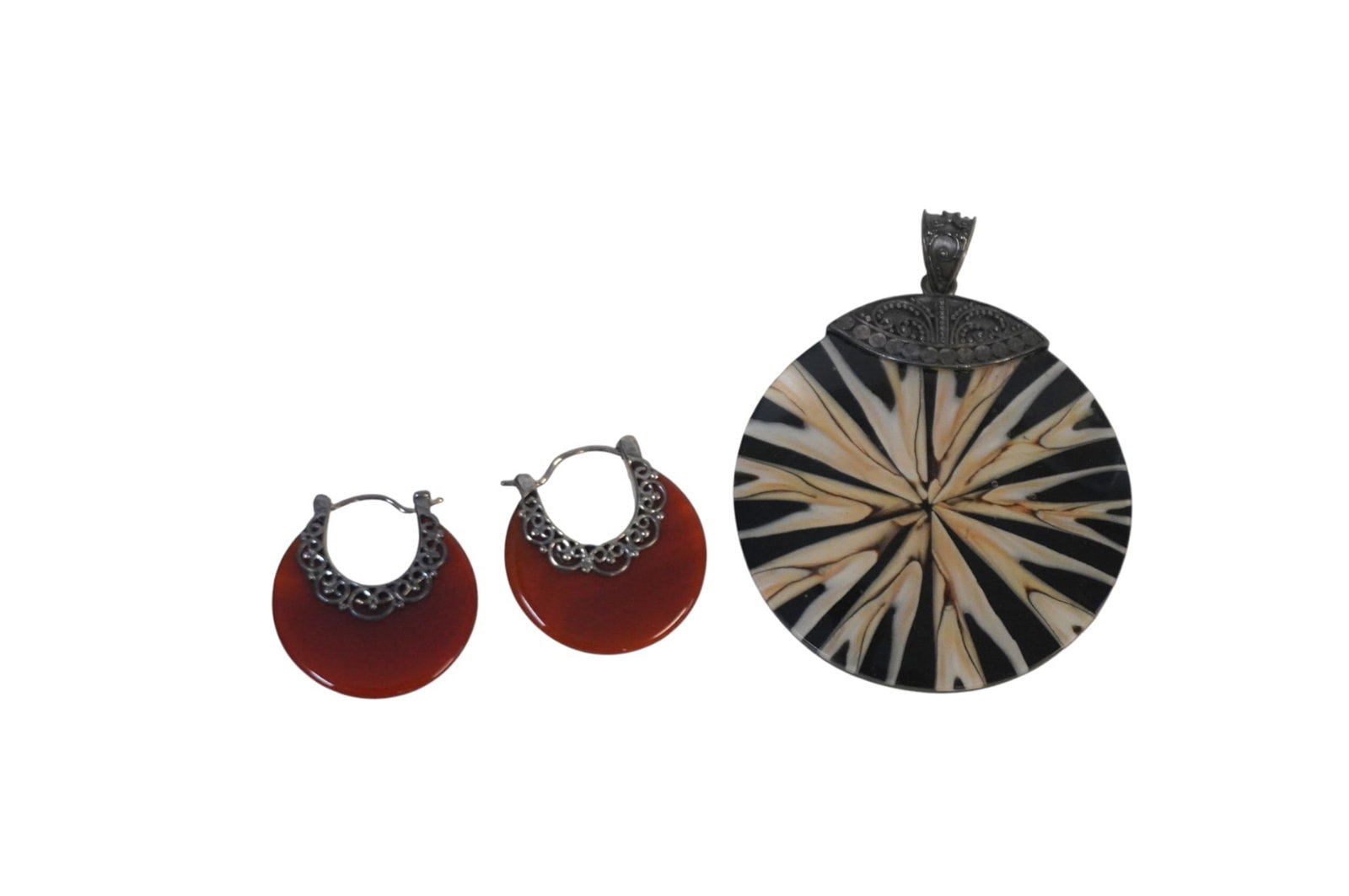 3 PIECES OF VINTAGE MERAN STERLING SILVER JEWELRY: This lot includes a pair of Sterling Silver and Carnelian Earrings and a pendant with Sterling Accent which is 2" in dia. Total lot weight is .9 oz.
