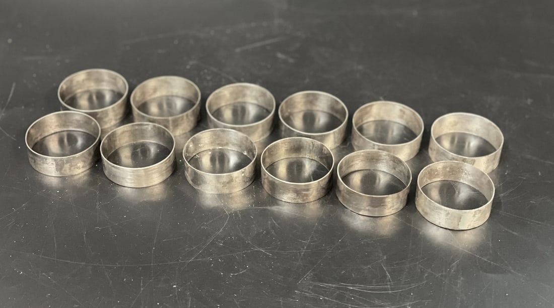 12 SILVER NAPKIN RINGS ST LOUIS SCHOOL BAGUIO CITY: 12 Mid Century Silver Napkin Rings created at the St. Louis School Baguio City, Philippines. In original box. Box measures 3.75"x3.75"x2". Weight in box 5 oz