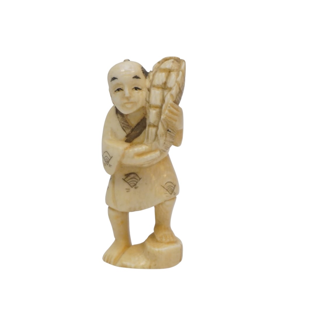 JAPANESE OKIMONO MAN WITH BASKET: Japanese Okimono, 19th Century. Carved, incised, and colored natural material.Man with basket, signed. 2 1/8". Weight 1/2" oz. Okimono is a Japanese term meaning ornament for display;, objet d'art; de
