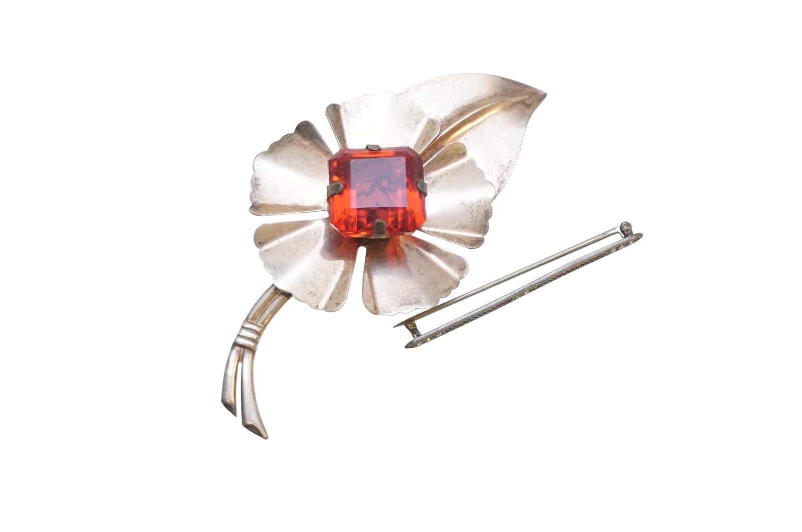 PAIR OF STERLING SILVER PINS: Pair of Sterling Silver Pins. Includes large flower sterling pin with red colored stone in the center, measures 4.25" x 2.25" and sterling Art Deco bar pin which measures 2.5", total lot weight is 1.3