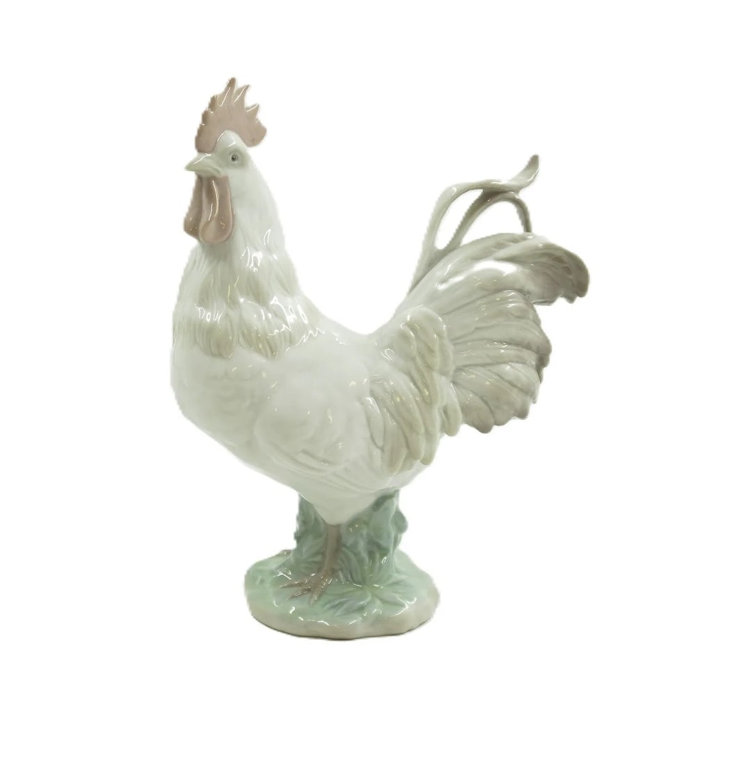 LLADRO ROOSTER ZODIAC FIGURINE: Lladro Zodiac Collection Rooster. Made in Spain. Signed and stamped on bottom. In the original Bloomingdale box. This piece measures 8" x 6" x 2.5". The box is 9 1/2"x6 1/2"x4". and weighs 1 lb 6 oz.
