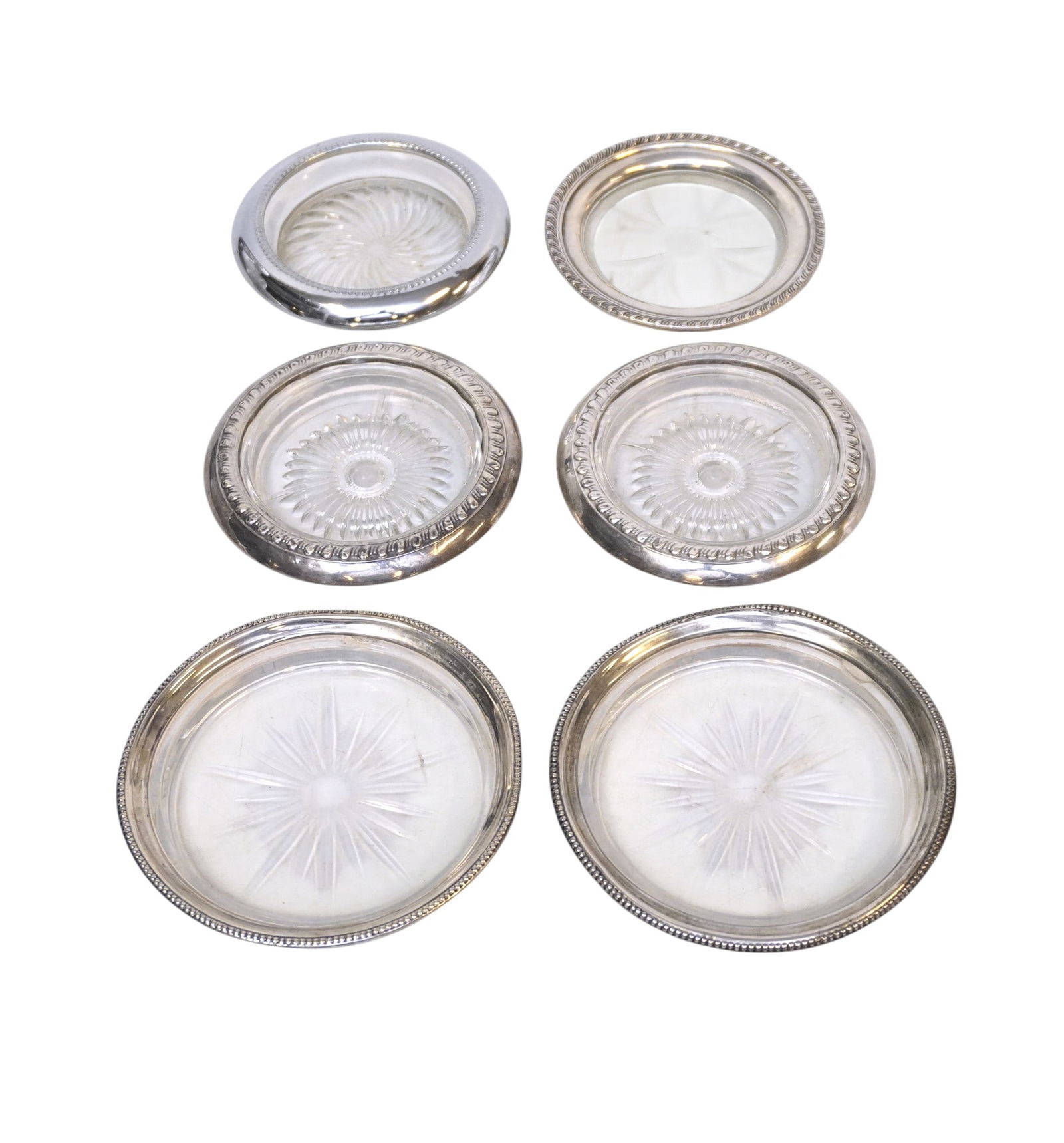 6 VINTAGE STERLING RIM COASTERS: 6 Vintage Sterling Rim Coasters. 2 for Bottles 4 for glasses. Minor wear. Wine Coasters 4 1/4". Weight on all 1 lb 9 oz