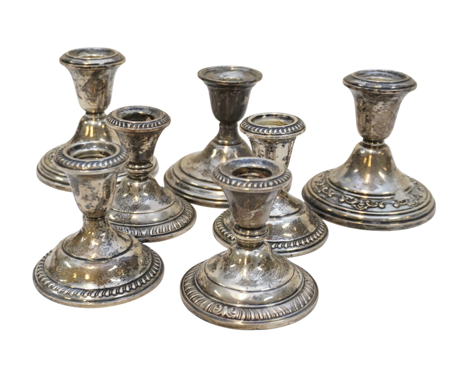 7 VINTAGE STERLING SILVER CANDLESTICKS: 7 Vintage Sterling Silver Candlesticks. All are weighted. Pairs includes Gorham, Empire, Frank M. Whiting. Single is Watrous. Tallest is 4". Weight on all 5 lbs 2 oz. Provenance: A Rainbow Row Private