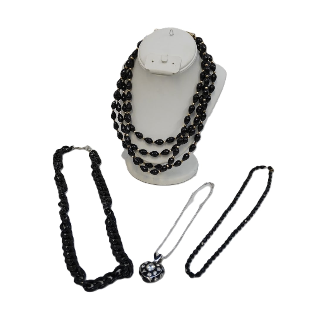 4 BLACK CONTEMPORARY & VINTAGE NECKLACES: 1- Black Enamel Rhinestone Heart in Saks 5th Box. 2- 4 Strand Horsebit Closure Necklace 3- Black Chain Necklace 28"opened. 4- Vintage Faceted Black Glass Necklace 22" opened. Weight on all 10 oz.