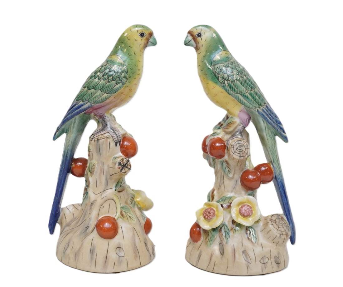VINTAGE PAIR OF CERAMIC PARROT FIGURINES ANDREA BY SADEK: Pair of Hand painted figural porcelain parrots , parrots are perched on a log with green leaves, red fruits, and Asian plum blossoms in relief. Parrots are painted yellow and green with blue and