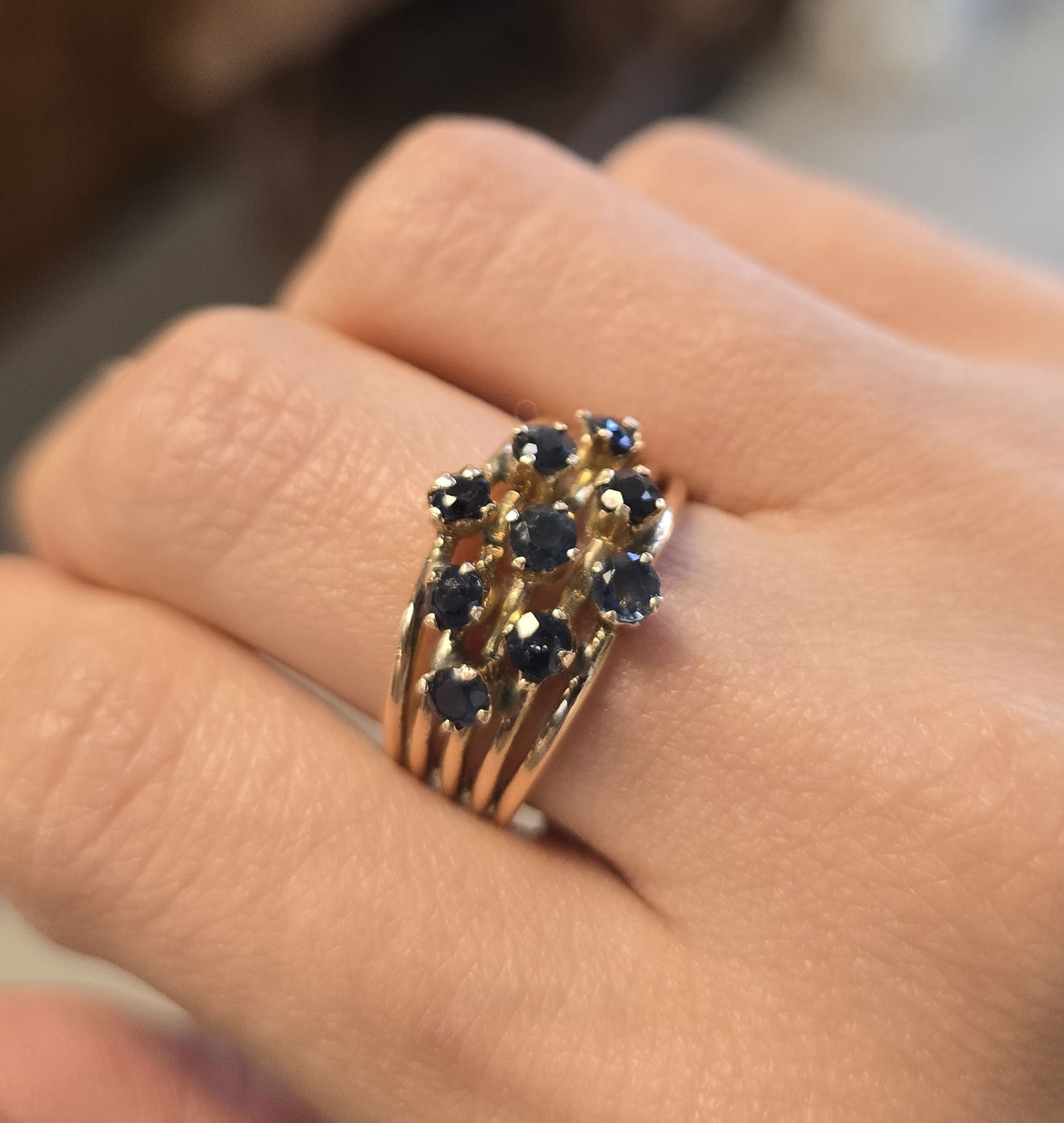 14k YELLOW GOLD SAPPHIRE CLUSTER RING: One ladies 14kt yellow gold sapphire ring. The ring is not stamped, but tested as 14kt yellow gold. The band measures 12.00mm by 6.00mm in width. The ring has 9 round 3.00 mm sapphires set in prongs