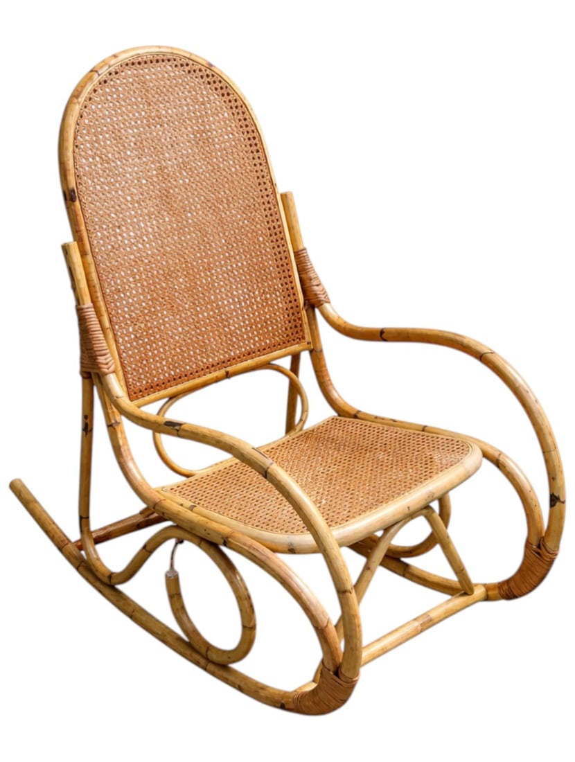 VINTAGE THONET STYLE BENTWOOD RATTAN ROCKING CHAIR: Vintage bentwood rattan rocking chair, circa 1960s-1970s. Featuring a high arched back with woven cane panel, matching cane seat, and sculptural looped rocker base with wrapped rattan joins. Measures