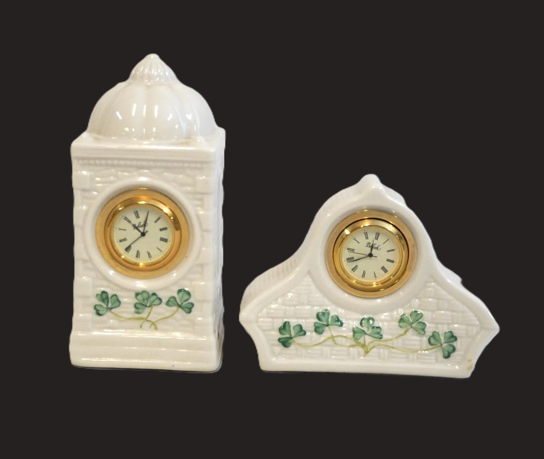 PAIR OF BELLEEK IRISH PORCELAIN SHAMROCK CLOCKS: Pair of Belleek Irish Porcelain Shamrock Desk Clocks. Larger measures approx. 6.5" x 3" x 3" and smaller is 5" x 2", total lot weight is 1 lb 2 oz. **In house shipping available on this lot** If you