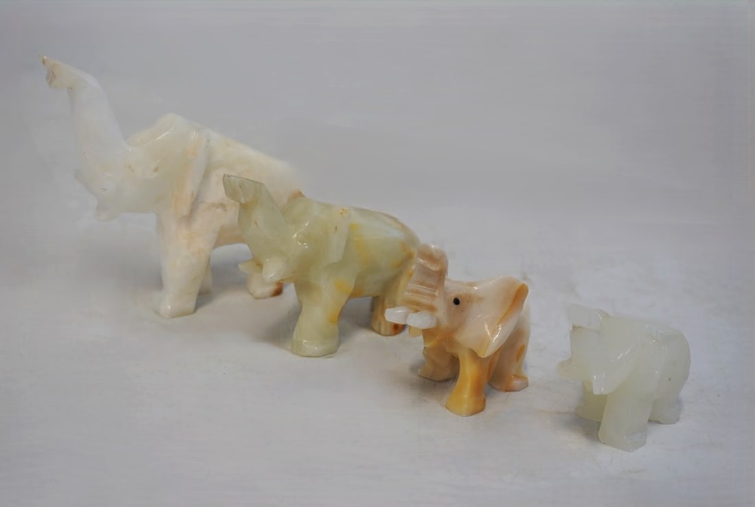 4 WHITE MARBLE AND ONYX CARVED ELEPHANTS: 4 White Carved Marble and Onyx Elephant Figurines. Largest measures approx. 4" x 5" x 2" and total lot weight is 1 lb 5 oz. **In house shipping available on this lot** If you win this lot, please