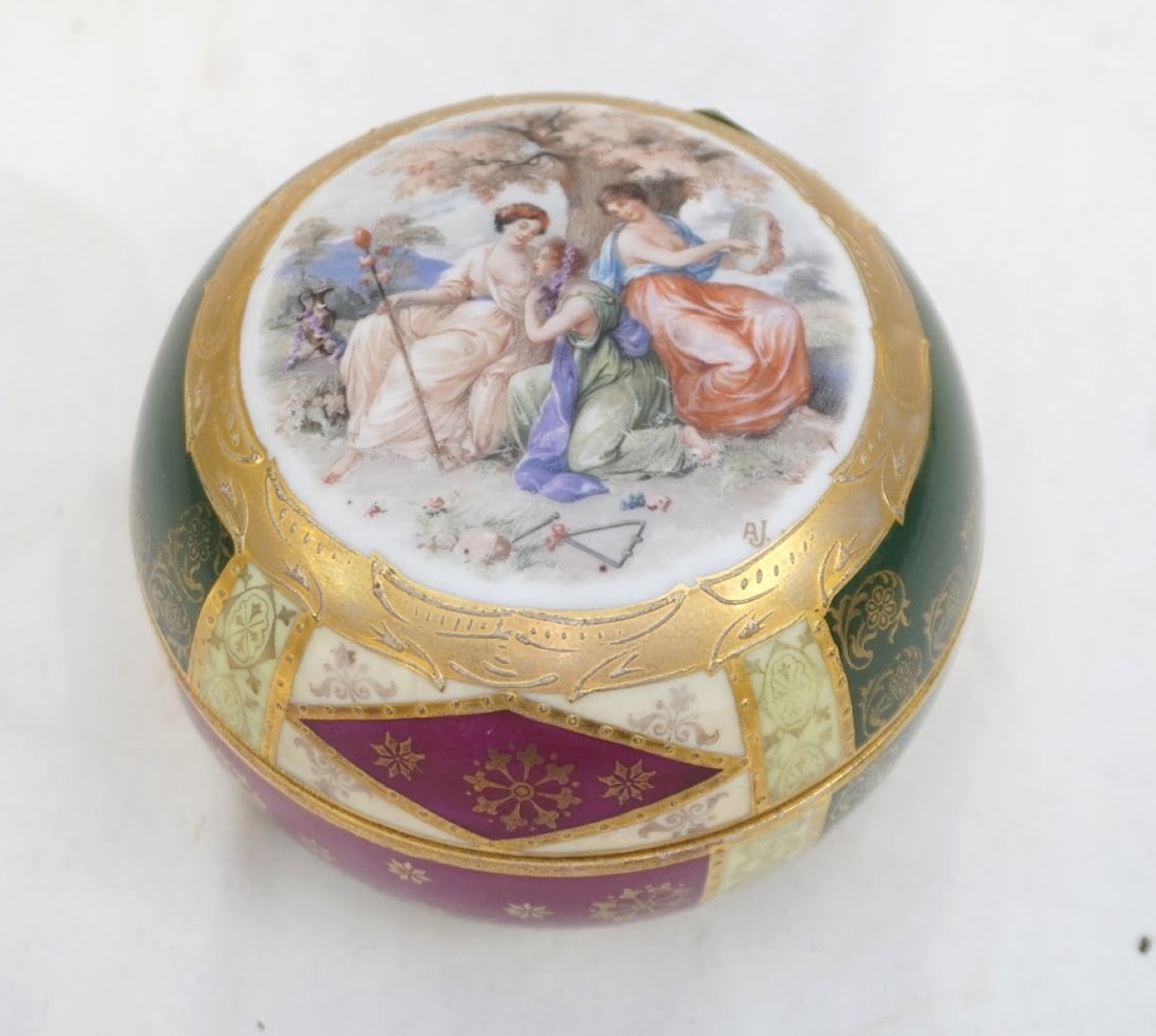VINTAGE WEST GERMAN PORCELAIN TRINKET BOX: Vintage Porcelain Trinket Box with heavy gilt accents in the style or by Royal Vienna. Measures 3.25" x 4.5" dia. and weighs 10 oz. **In house shipping available on this lot** If you win this lot,