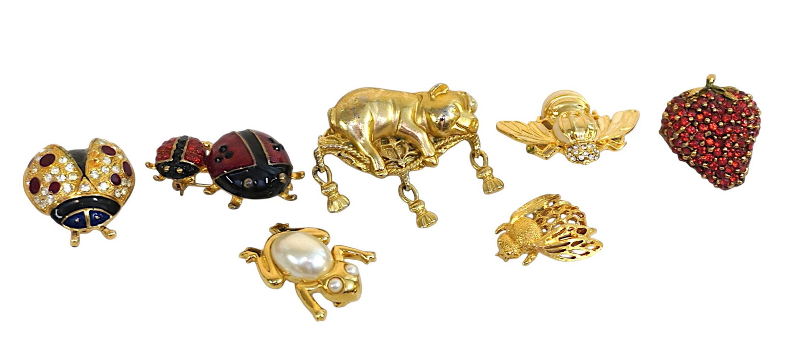 7 VINTAGE BROOCHES INSECTS, PIG, FROG & BERRY: 1- Cinar Jeweled Strawberry Brooch 1 1/4". 2- AJC Pig on a Pillow Brooch 2". 3- Napier Faux Pearl Frog. 1 1/4". 4- Enamel and Rhinestone Ladybug & Baby Brooch 1 1/2" 5- Napier Bumble Bee Brooch 1". 6-