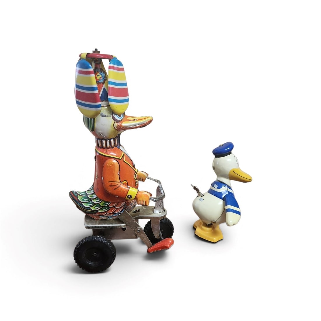 2 PIECE VINTAGE TIN WIND UPS DONALD DUCK & DUCK ON BIKE: 1- Disney Young Epoch Retro Toy Collection Donald Duck. Waddles well 4 1/2". 2- Vintage Tin Schylling Duck on a Bike Wind Up. Works well, 8". Weight 8 oz.