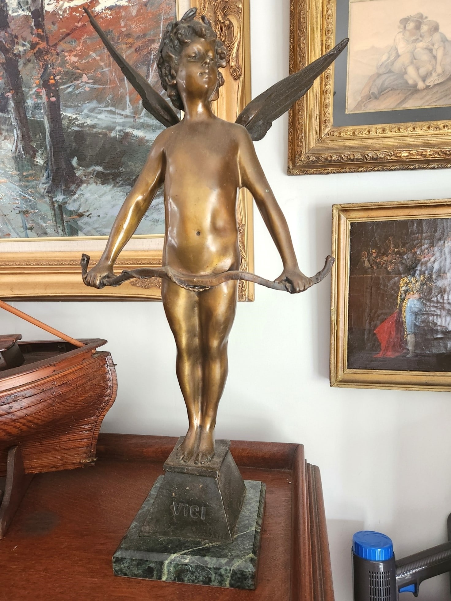 19th c VICI FRENCH BRONZE AUGUSTE MOREAU 24": Late 19th c. "Vici" winged cupid with bow. Cast bronze statue after Auguste Moreau with well detailed wings and hair. Incised signature to vase, worn foundry medallion to back base. Measures