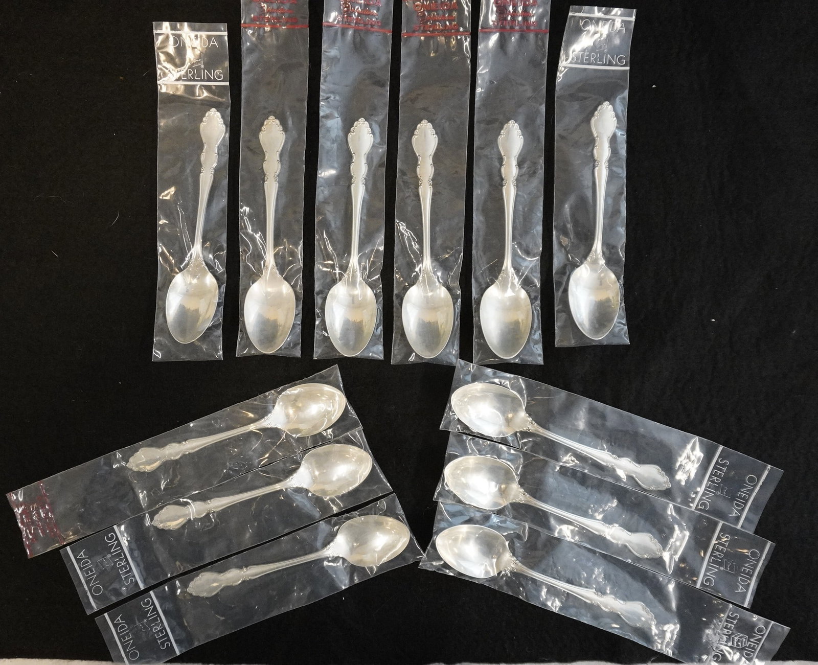12 STERLING SILVER DOVER TEASPOONS UNUSED: Twelve (12) Vintage Heirloom Sterling Silver "Dover" Pattern Teaspoons by Oneida. Each 6". Still in the original packaging. Excellent condition, never used. Approximate silver weight 384 grams. **In