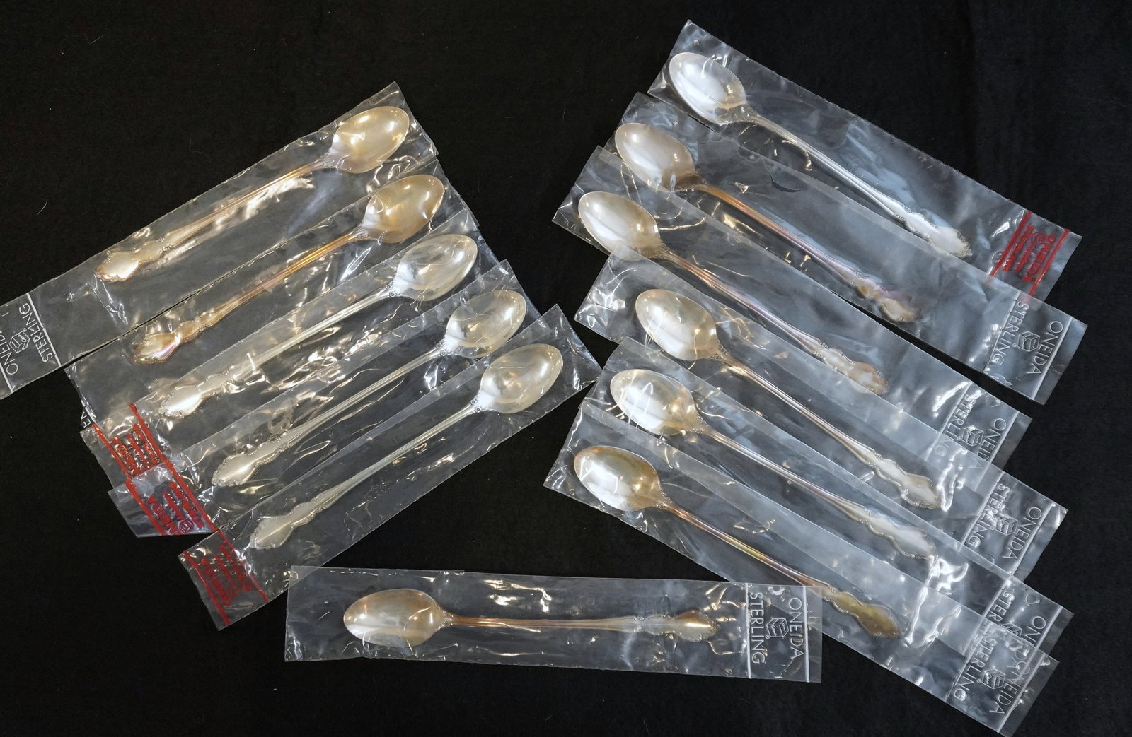 12 STERLING SILVER DOVER ICED SPOONS UNUSED: Twelve (12) Vintage Heirloom Sterling Silver "Dover" Pattern Iced Tea Spoons by Oneida. Each 7 3/8". Still in the original packaging. Excellent condition, never used. Approximate silver weight 420
