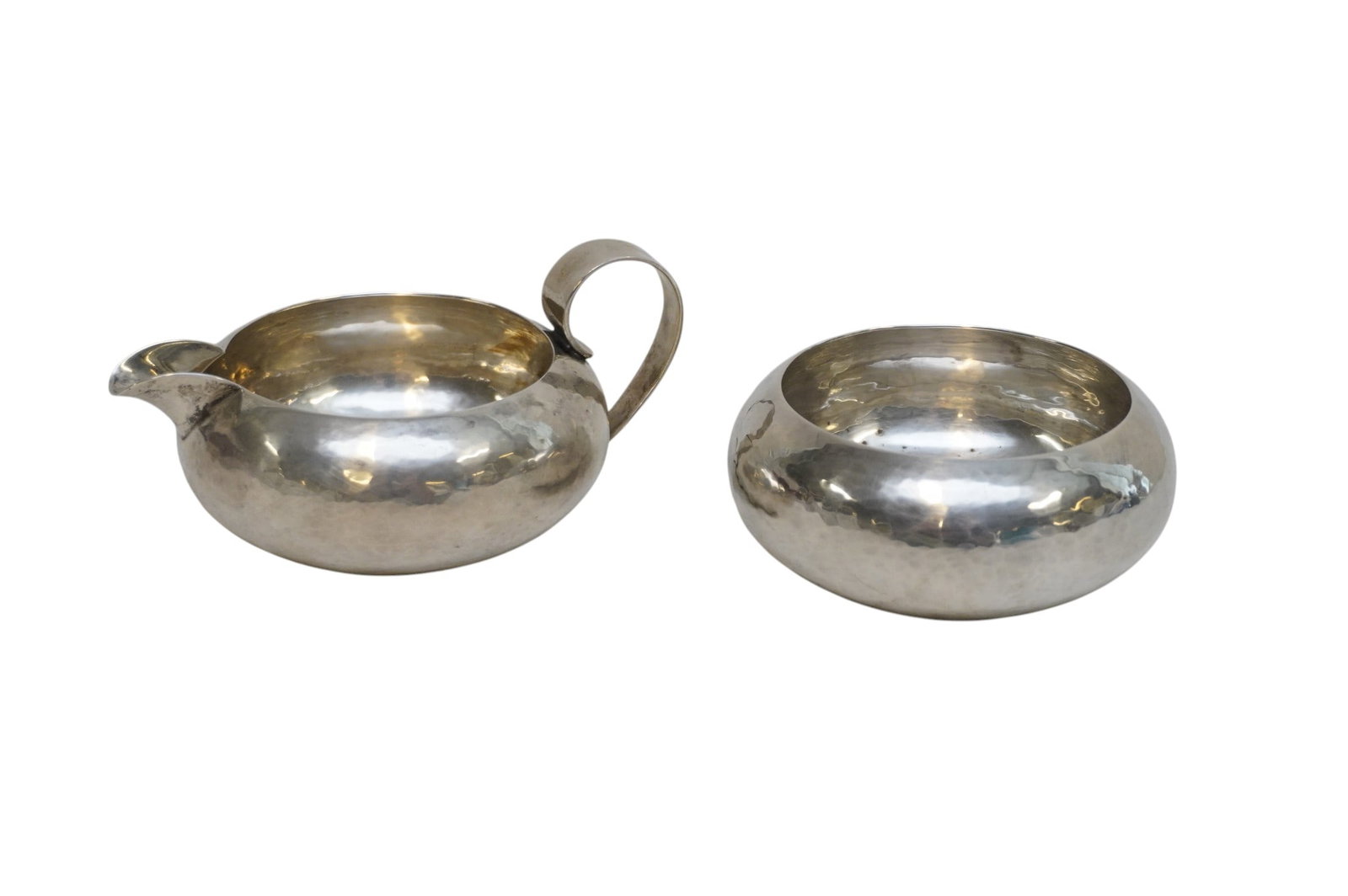 STERLING SILVER ARTS & CRAFTS PORTER BLANCHARD CREAM & SUGAR: Porter Blanchard Sterling Silver Arts & Crafts Hand Hammered Cream & Sugar. Creamer 5"x2 1/2" and Sugar 3 3/4"x1 3/4". Approximate silver weight 280 grams. Porter Blanchard Sterling is a legacy of