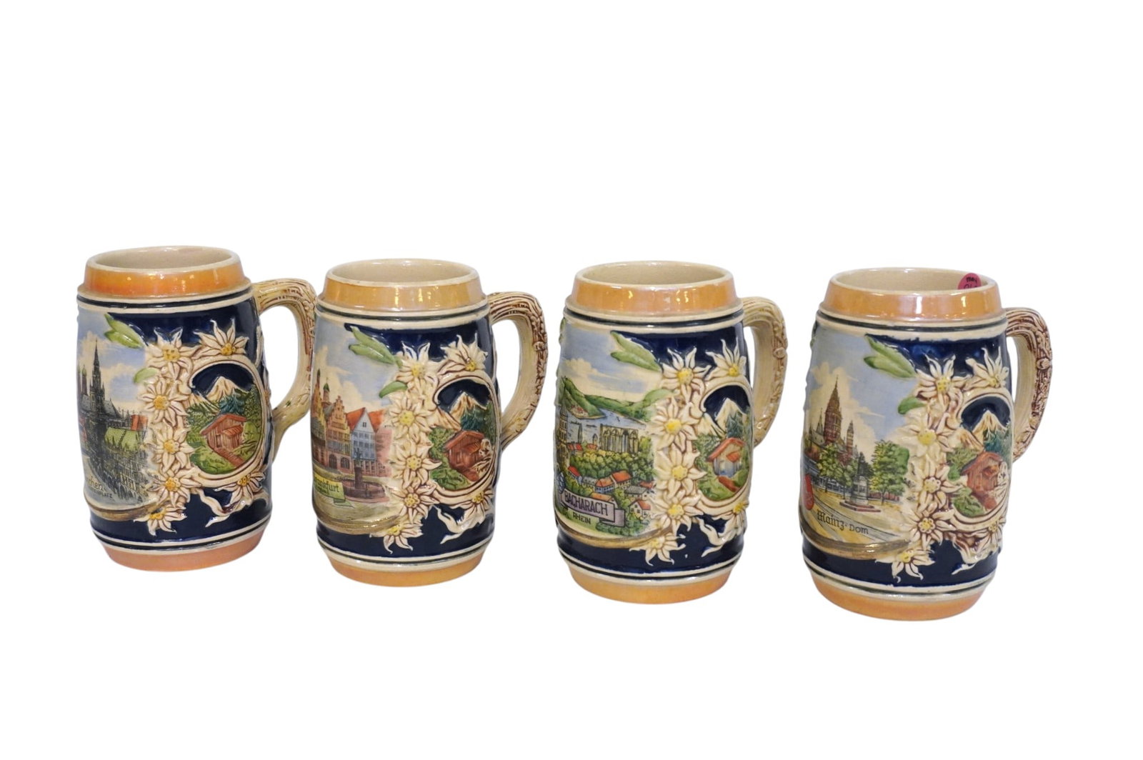 SET OF 4 VINTAGE STEINS: Set of 4 Vintage German Steins. Each measures approx. 6.25" x 5" x 4" and weighs 4 lbs 12 oz.