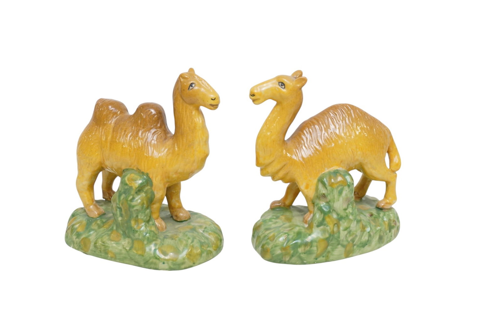 PAIR VINTAGE STAFFORDSHIRE STYLE POTTERY CAMELS: Pair of Vintage Staffordshire Style Camels. Each 6"x4"x7". Weight combined 2 lbs 10 oz. PROVENANCE The Historic R.M. Venning House, Charleston SC **In house shipping available on this lot** If you