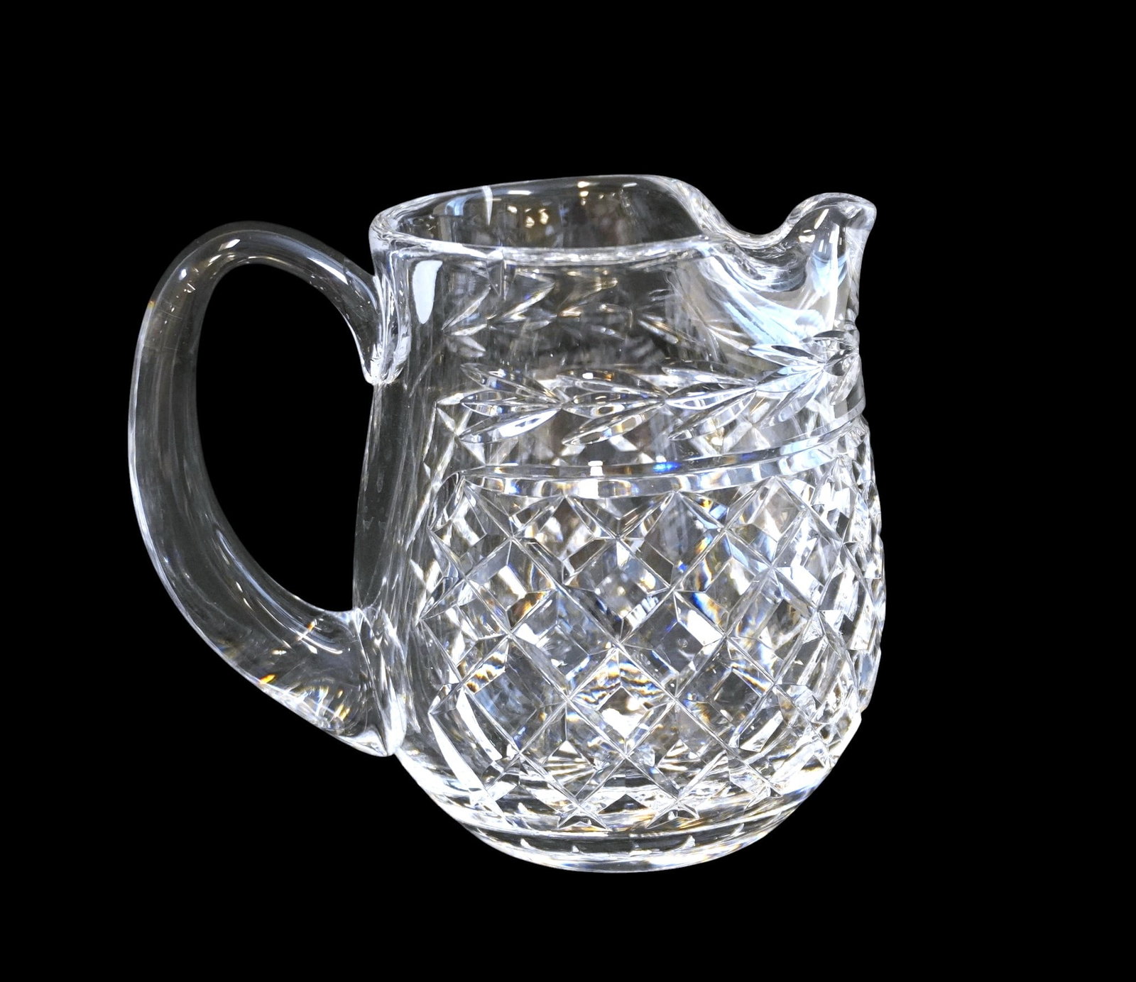 WATERFORD GLANDORE WATER PITCHER: Waterford Glandore Water Pitcher. Measures approx. 6" x 7" x 4.5" and weighs 3 lbs 2 oz. **In house shipping available on this lot** If you win this lot, please select self arranged for in house shipp