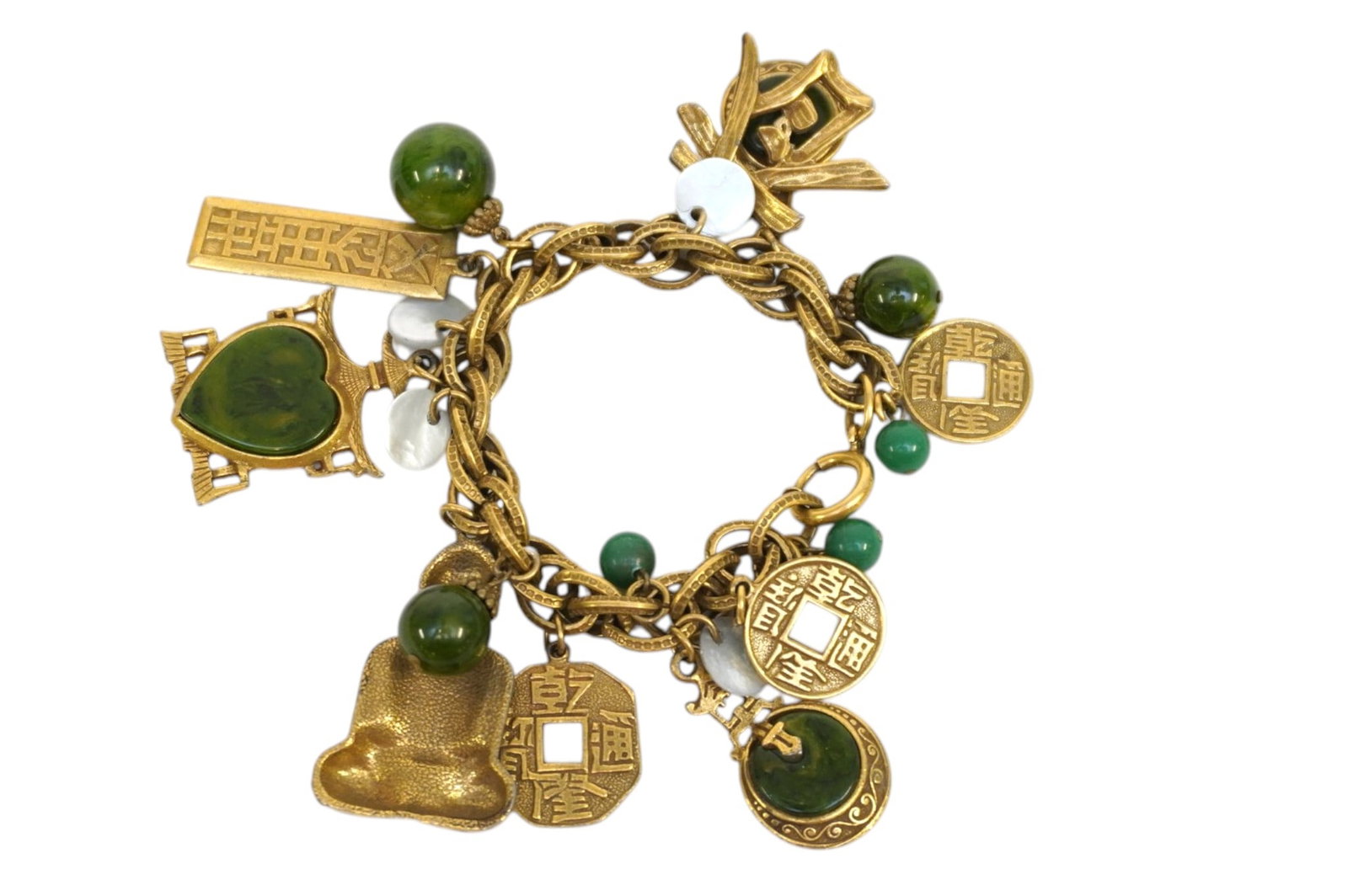 SIGNED ART VINTAGE GREEN LUCITE ASIAN CHARM BRACELET: Signed Art Vintage Green Lucite Asian Charm Bracelet. Measures approx. 7.5" and weighs 2.6 oz. **In house shipping available on this lot** If you win this lot, please select self arranged for in house