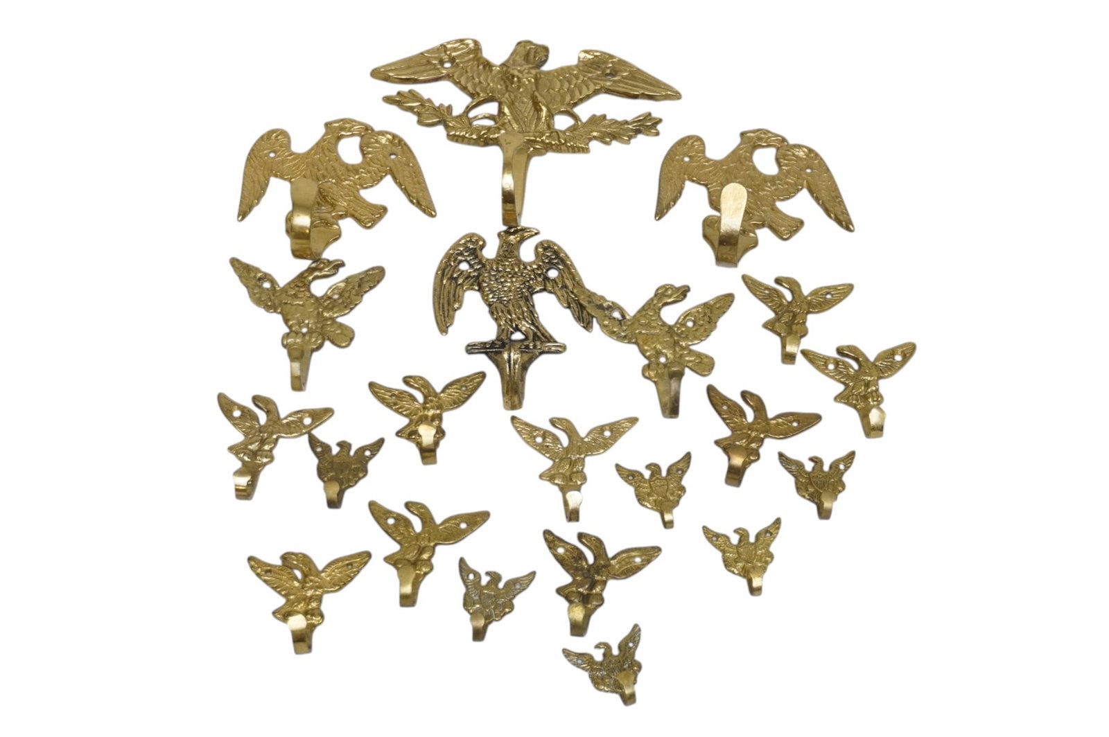 COLLECTION OF VINTAGE BRASS EAGLE HOOKS AMERICANA WALL DECOR - 21 PIECES: 21 piece collection of vintage brass eagle hooks/ wall hangers. Largest measures approximately 5" x 6.5". Combined approximate weight 2 lbs 5 oz.**In house shipping available on this lot** If you win 