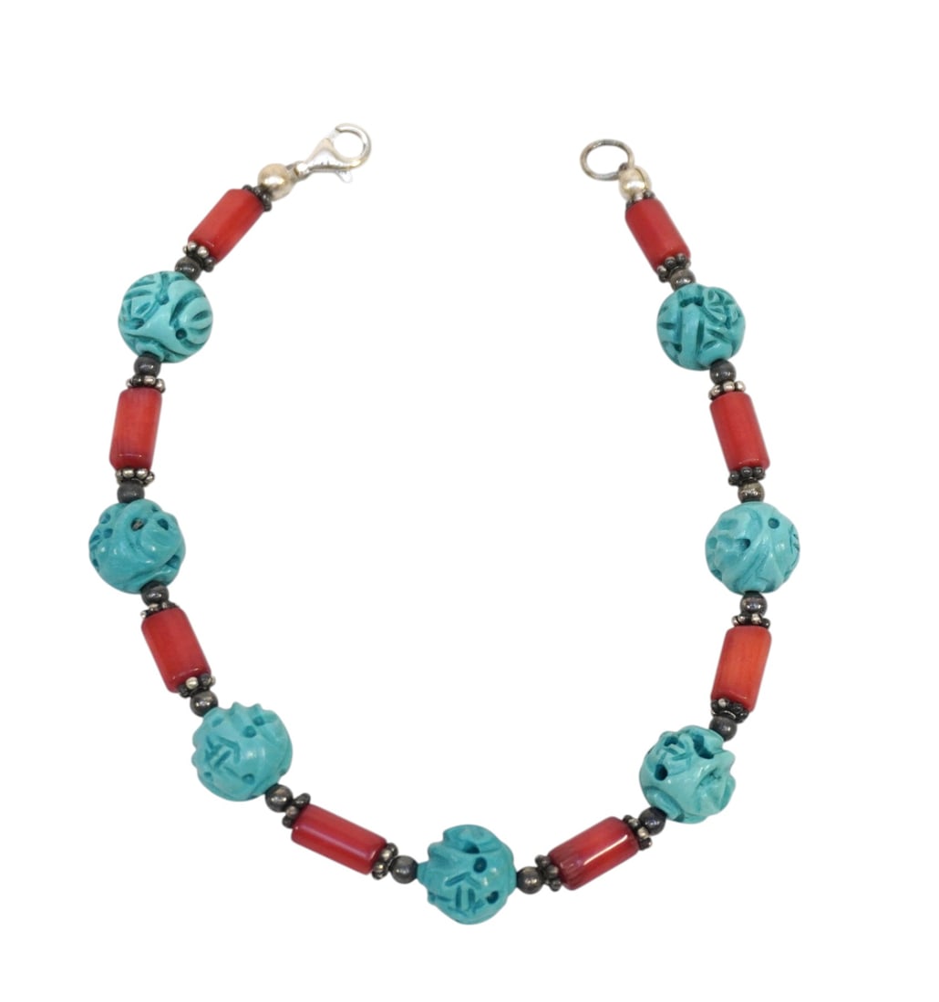 CARVED HOWLITE & CORAL BRACELET.: Carved Howlite & Coral Beaded Bracelet 8" opened. Weight 1 oz **In house shipping available on this lot** If you win this lot, please select self arranged for in house shipping when paying**
