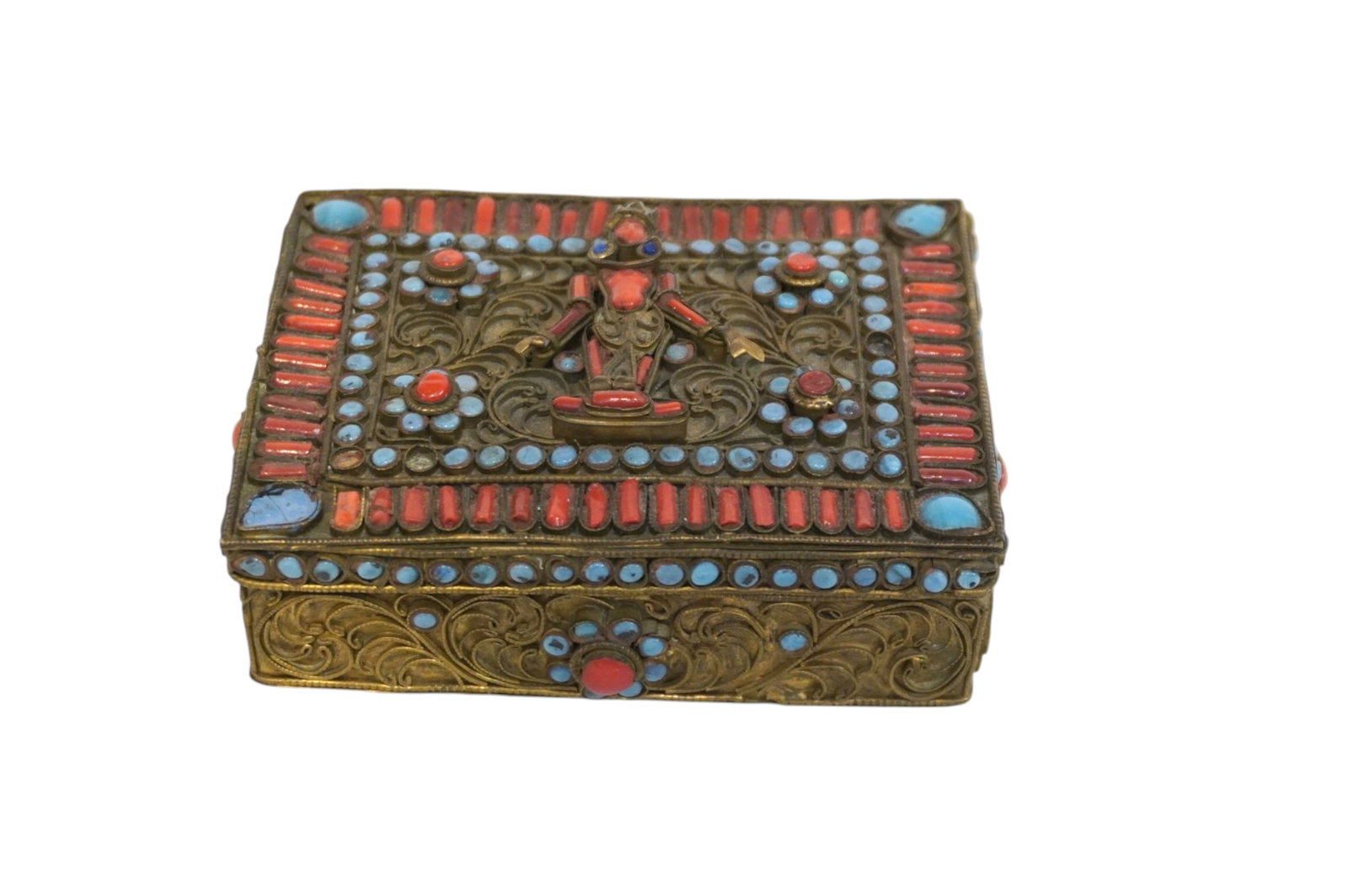EARLY TIBETAN PRAYER BOX TURQUOISE & CORAL: 19th c Early Tibetan Prayer Box. Gilt metal, hinged with turquoise and coral stones. Measures 4.25"x3"x1 1/2". Weight 5.2 oz. **In house shipping available on this lot** If you win this lot, please