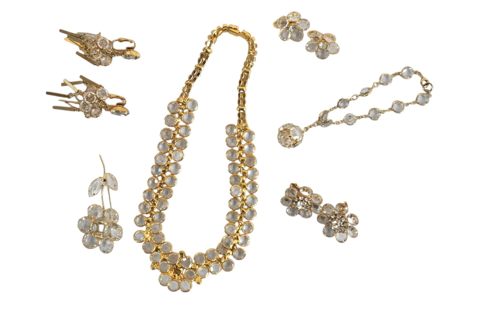 9 PC VINTAGE MCM CLEAR AND RHINESTONE PARURE PLUS: Vintage MCM 1950-60 Statement Demi Parure and Extra, All are prong set. All purchased at Marshall Fields. Includes Necklace of Clear and Rhinestone, Flower Center 15" opened. Matching Flower Brooch 2 