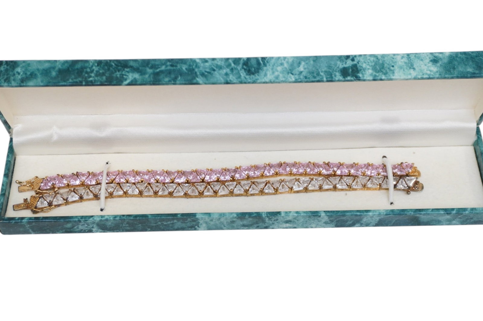 PAIR SUZANNE SOMERS STERLING CUBIC ZIRCONIA BRACELETS: Two Vintage Suzanne Somers Vermeil over Sterling Silver Trillion Cubic Zirconia Bracelets in Pink and Clear. Suzanne Somers' vintage jewelry line was well known for her popular cubic zirconia trillian