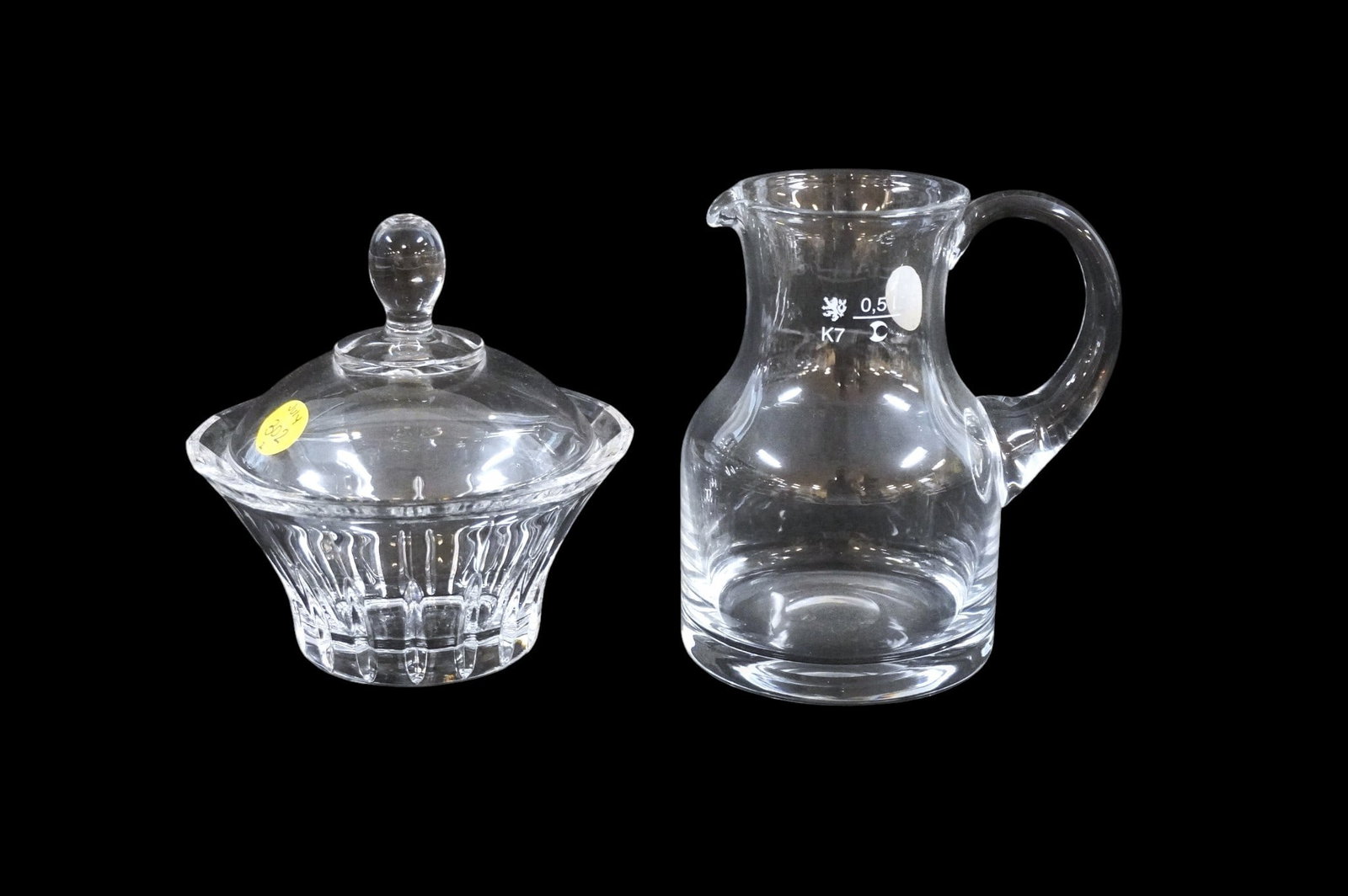 2 VINTAGE GLASS PIECES - JUICE PITCHER AND BONBON DISH: 2 Vintage Glass Pieces. Juice Pitcher which measures approx. 6" x 5" x 3.5" and Covered BonBon Dish which measures approx. 6" x 5.25" in dia. total lot weight is approx. 2 lbs 14 oz. **In house shippi