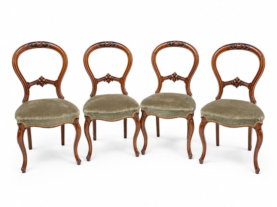SET OF 4 VICTORIAN CARVED WALNUT BALLOON-BACK CHAIRS: A handsome matched set of four Victorian walnut balloon-back side chairs with carved and pierced foliate decoration, contrasting dark- stained grounds, serpentine upholstered seats and cabriole front