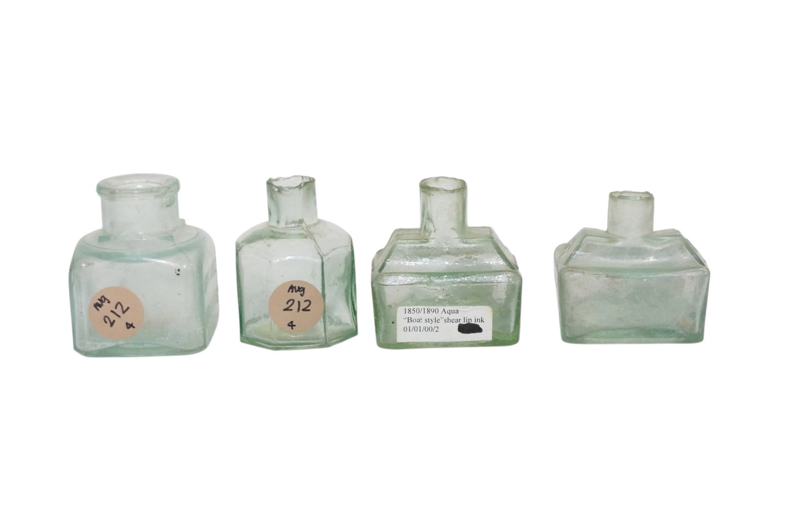 4 ANTIQUE AQUA GLASS INKWELLS: 4 Antique Aqua Glass Inkwells. Largest measures approx. 2" x 2" x 2.25" amd total lot weight is 9..5 oz.