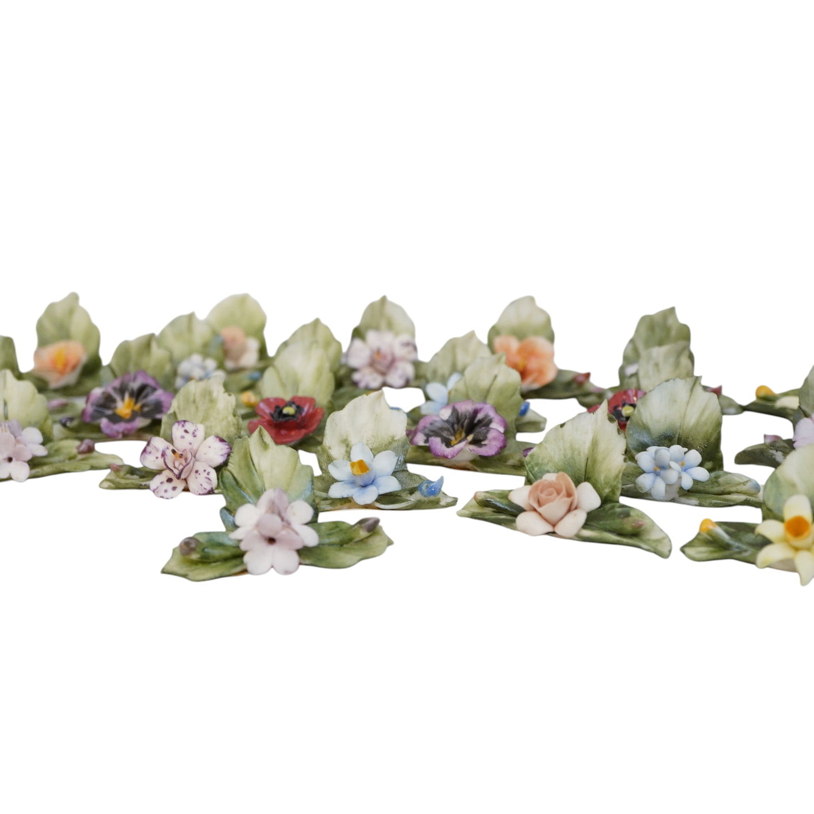 24 ITALIAN CAPODIMONTE PLACE CARD HOLDERS - HORCHOW: 24 Vintage Italian Capodimonte Sculpted, Hand Painted Place Card Holders. Each approximately 2 1/4"x1 3/4".In box 5"x5"x3 1/2". Weight on all in box 11 oz. PROVENANCE: The Estate of Dr. Fraser
