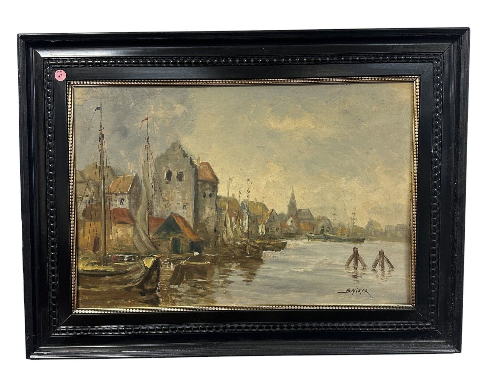 FRANS BAKKER SIGNED OIL ON BOARD: An antique oil on board painting by Frans Bakker (Dutch, 1871-1944). This work depicts a waterside dutch village with sailboats. It is signed on the lower right. Framed in black painted wood with gold