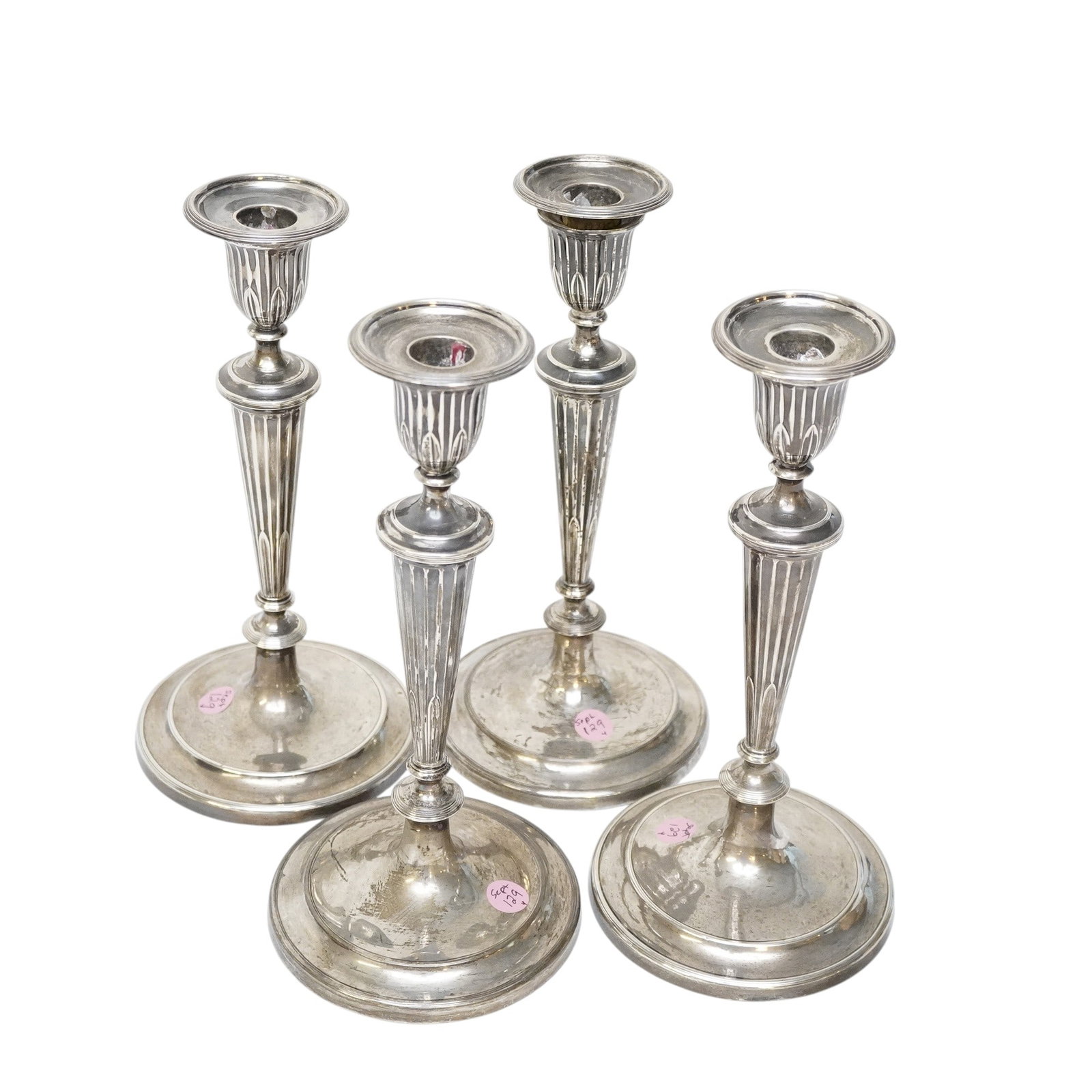 A SET OF FOUR GEORGE III STERLING CANDLESTICKS (1 of 3)