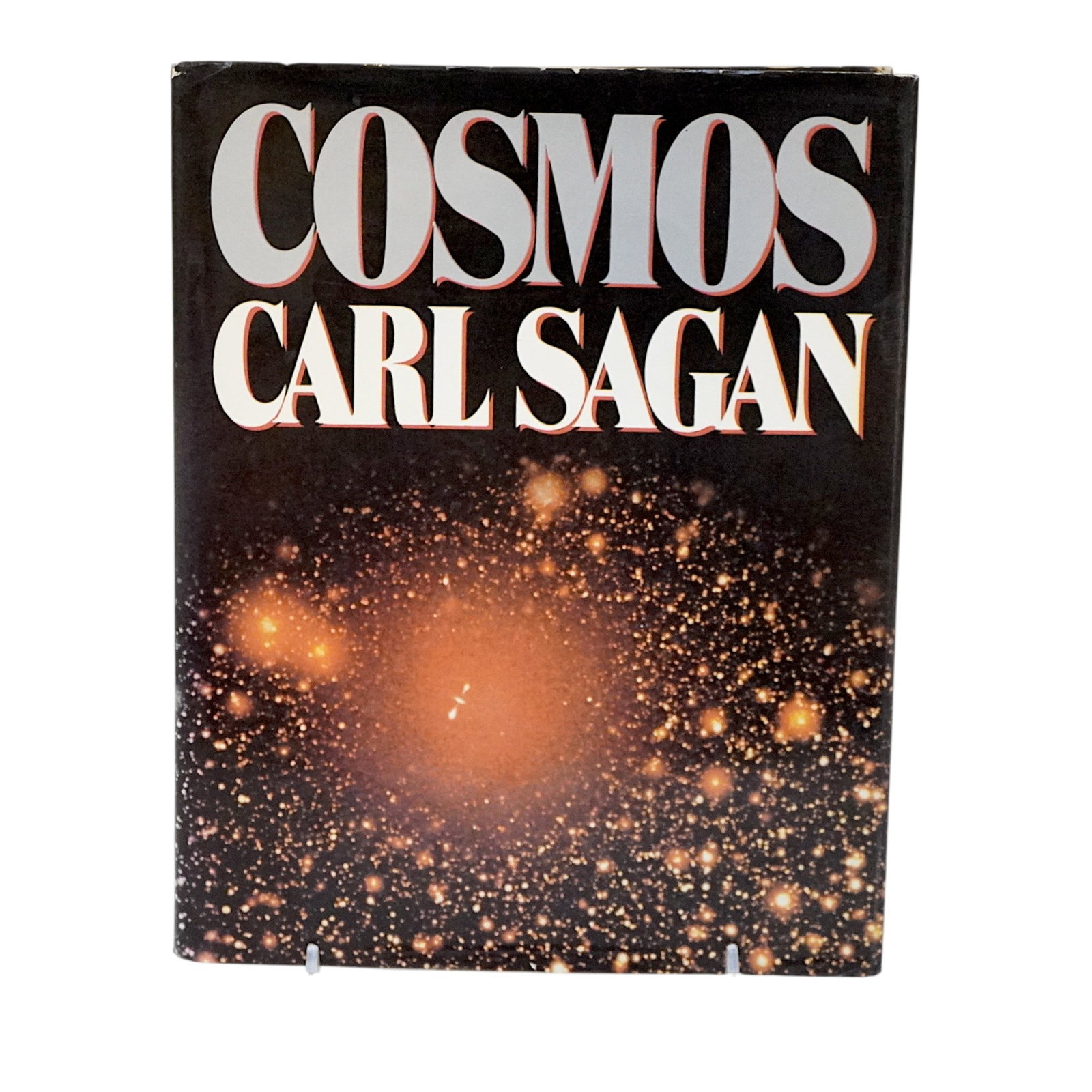 SIGNED CARL SAGAN "COSMOS" BOOK 1980: Carl Sagan (1934-1996) signed book. Cosmos. c. 1980, first edition, third printing. Signed on title page. In very good condition with light edge wear to jacket. Measures 8"x10 1/4"x1n1/4". Weight 2