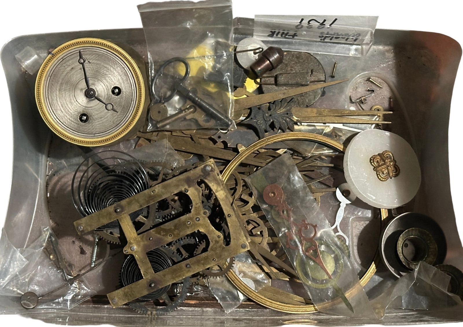 HOROLOGIST'S COLLECTION OF ANTIQUE & VINTAGE CLOCK PARTS: A comprehensive bulk estate lot specifically curated for clock smiths, restorers, and horological hobbyists. This diverse accumulation includes a wide variety of hardware, frames, and components spann