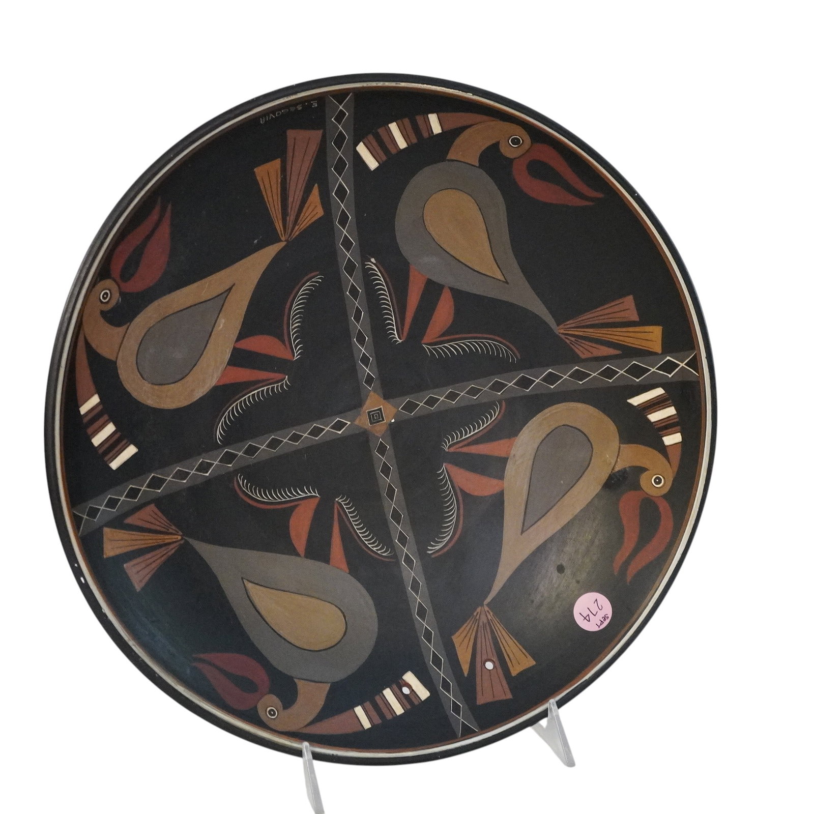 ECUADORIAN FOLK ART POTTERY PLATE BY EDUARDO SEGOVIA: Ecuadorian Folk Art Pottery Plater by Eduardo Segovia. Has holes for hanging, signed by artist on lower right hand side. Measures approx. 2.25" x 12.5" in dia. and weighs 2 lbs 9 oz. **In house shippi