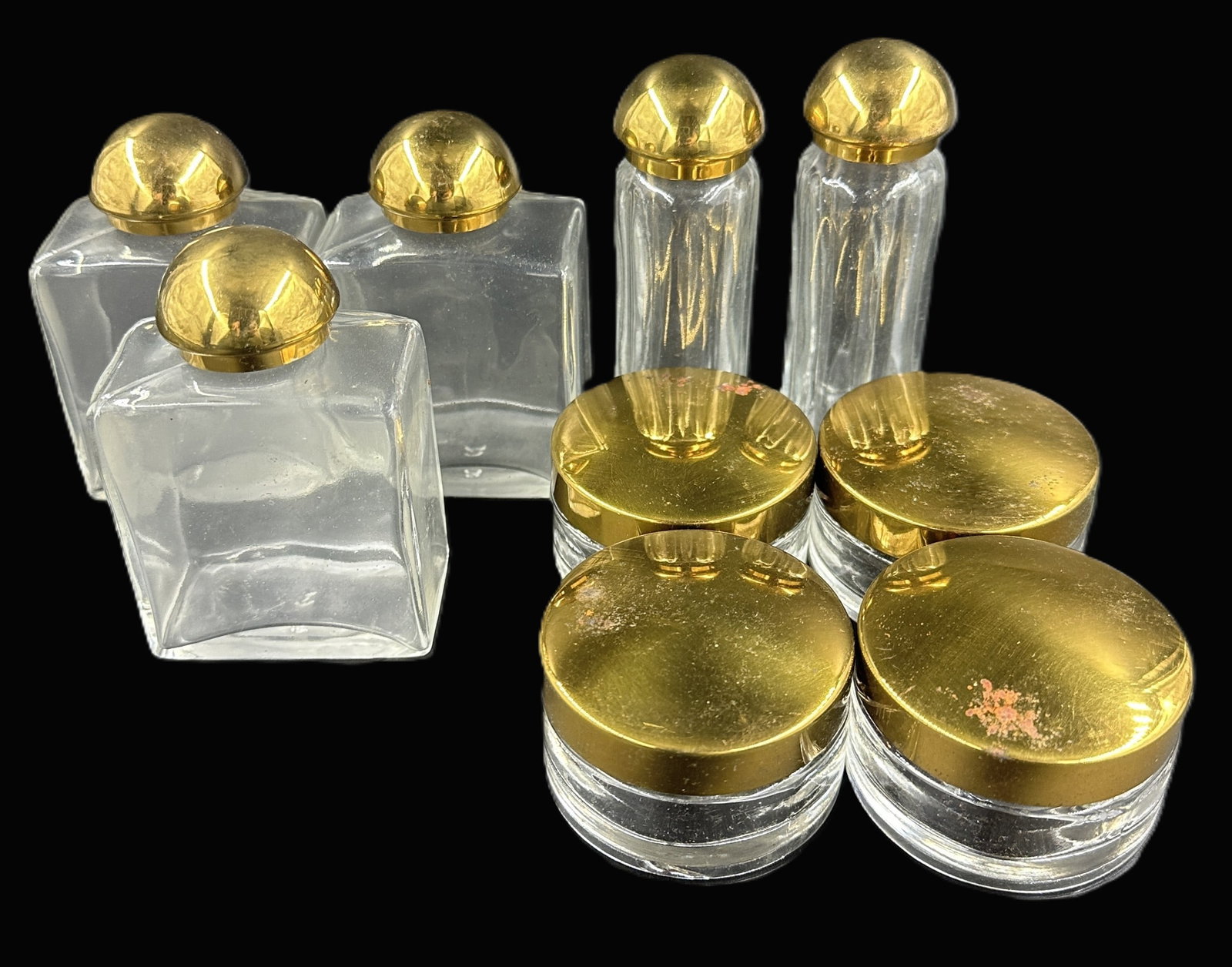 9 PIECE MID CENTURY VANITY SET: Nine Piece Vintage Vanity Set with Cologne / Lotion Bottlles. 4 Cream Jars and 2 Perfume Bottles. Perfumes measure 3 3/4". Weight on all combined 2 lbs 5 oz. **In house shipping available on this lot*