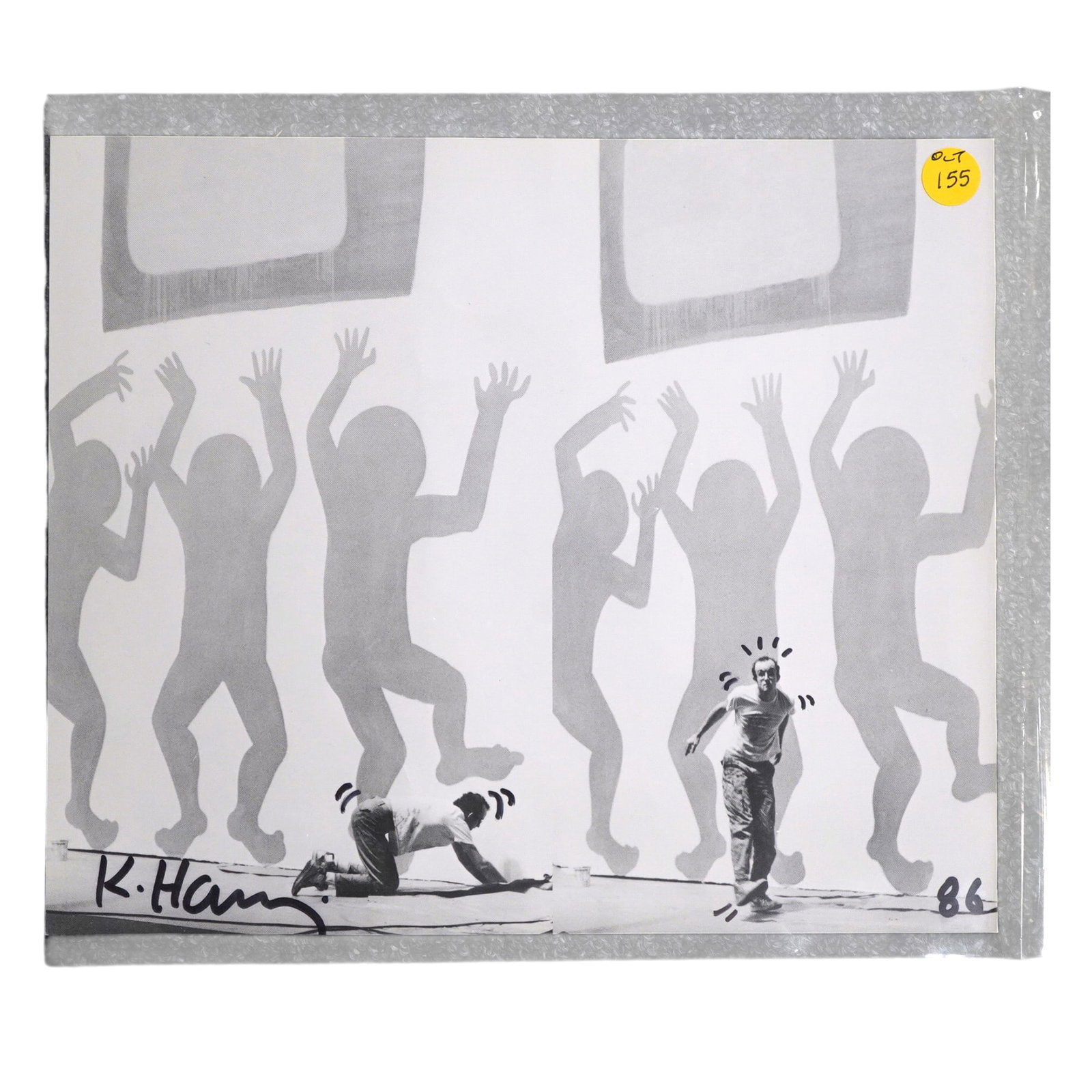 KEITH HARING SIGNED 1986 CATALOGUE PHOTO WITH DRAWN EMBELLISHMENTS: Keith Haring signed 1986 catalogue photo. This page was part of the Stedelijk Museum catalogue. Marker signed with drawn embellishments. Very good condition. 10" x 12". Weight 4 oz. Signature has not 