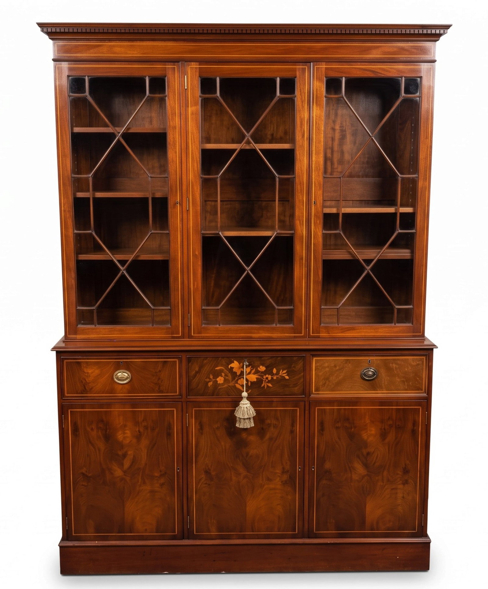 GEORGE III STYLE ENGLISH INLAID FLAME MAHOGANY BOOKCASE: Magnificent George III style English Bench Made Inlaid Mahogany Bookcase.Crafted from high quality mahogany with a flame grain, with satinwood crossbanding, classical floral marquetry inlay and glazed