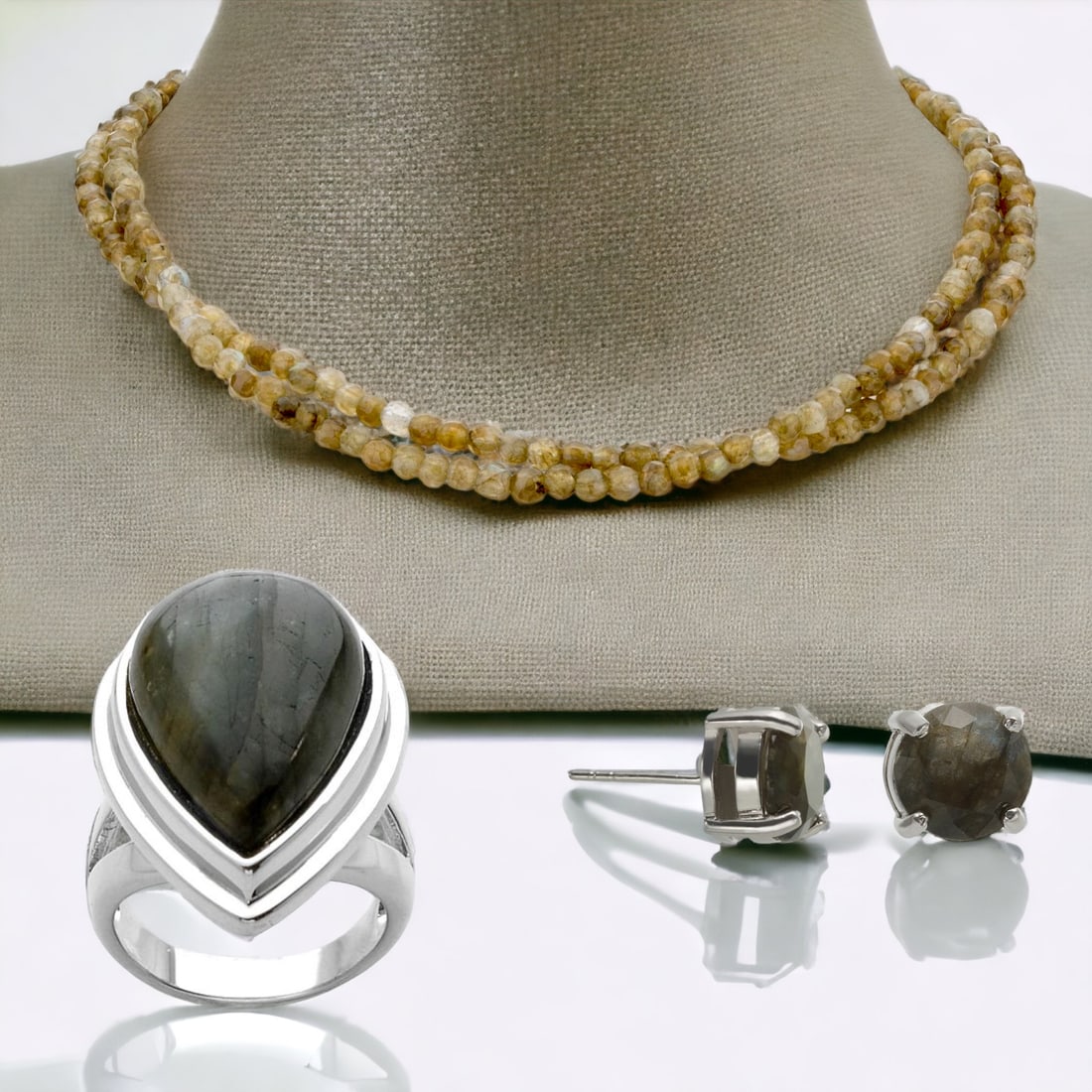 Iridescent Labradorite Jewelry Ensemble: Dive into the mesmerizing world of labradorite with this exquisite jewelry set. The 17" Double Strand Labradorite Necklace beautifully captures the iridescence of the gemstone, reflecting hues of blue