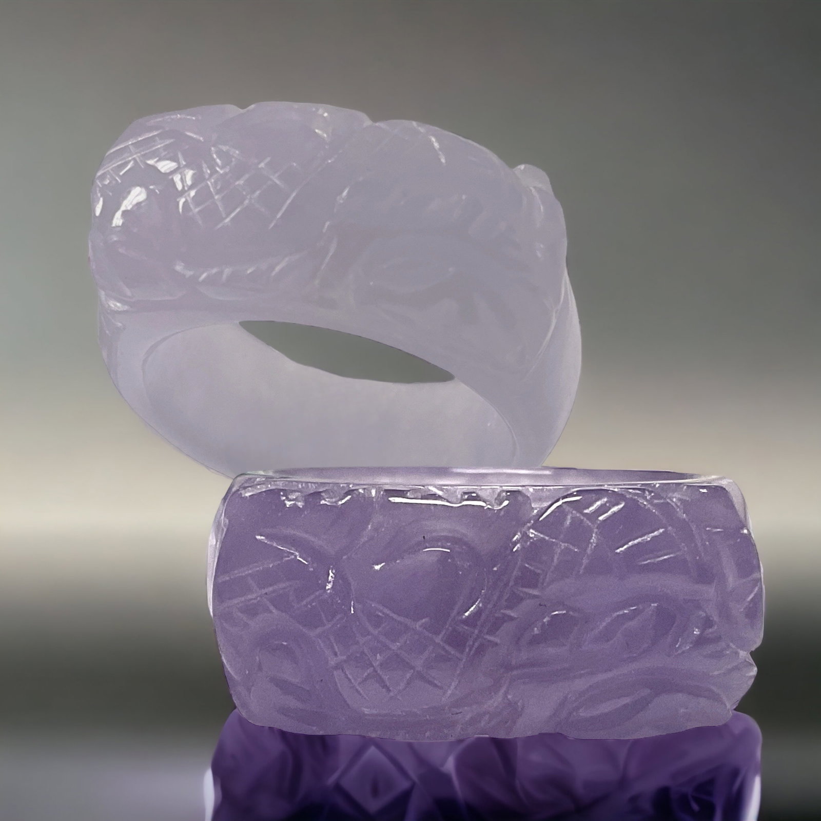 Exquisite Carved Purple Jade Ring - Size 8: Adorn your hand with this exquisitely carved purple jade ring in a size 8, showcasing intricate craftsmanship and the natural beauty of the stone. The deep, rich hues of the purple jade create an air