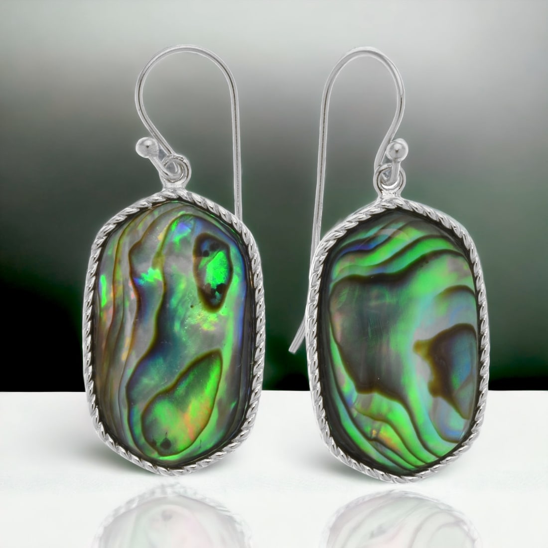 Iridescent Abalone Sterling Silver Earrings: Embrace the enchanting allure of the ocean with these Iridescent Abalone Sterling Silver Earrings. The mesmerizing play of colors in the abalone shells is complemented by the elegant sterling silver s