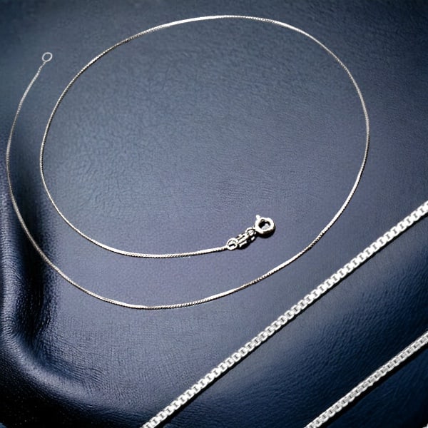 Classic Sterling Silver 18" Box Chain: Here is a timeless 18" sterling silver box chain, offering versatility and elegance for everyday wear. The classic design and durable craftsmanship make this chain a staple accessory, perfect for show