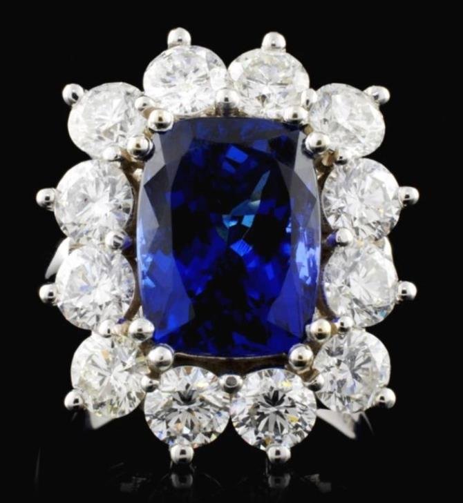 18K Gold 5.64ct Tanzanite & 3.75ct Diamond Ring: Gold Content: 18K White GoldWeight of Item: 10.20 gramsSize: 7Main Gemstone: Natural TanzaniteShape: Cushion cutCut Grade: Very GoodTotal Carat Weight: 5.64ctColor: Violetish Blue, Very Even ColorAdja